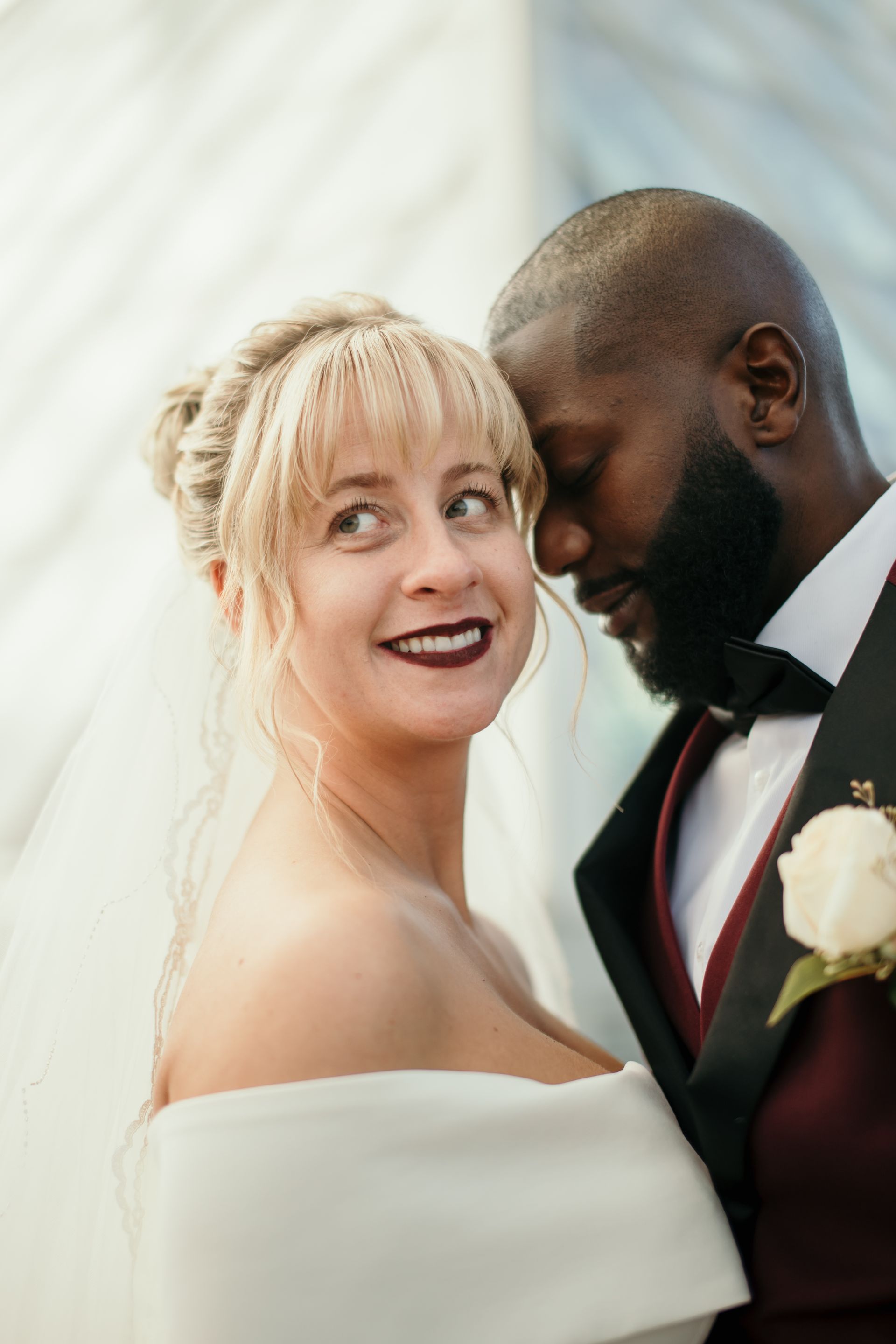 A bride and groom are posing for a picture on their wedding day.