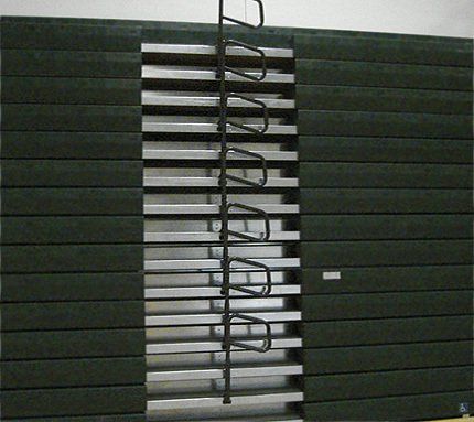 Closeup of Interkal quarter-turn aisle rails in closed position on a closed telescopic bleacher.