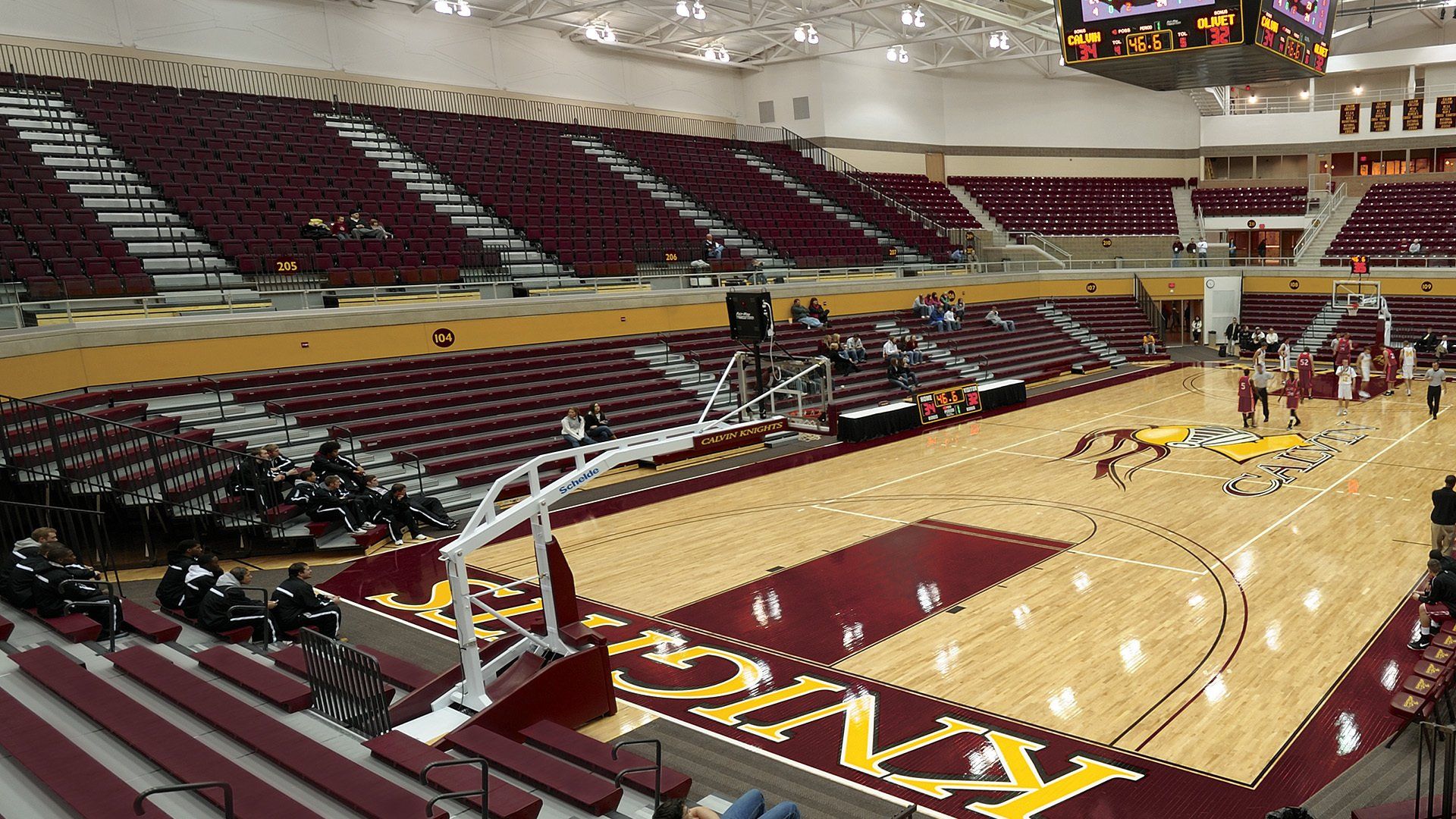 Burgundy Interkal Contour Seat Modules and VISION Platform Chairs on display at the basketball court at Calvin University.