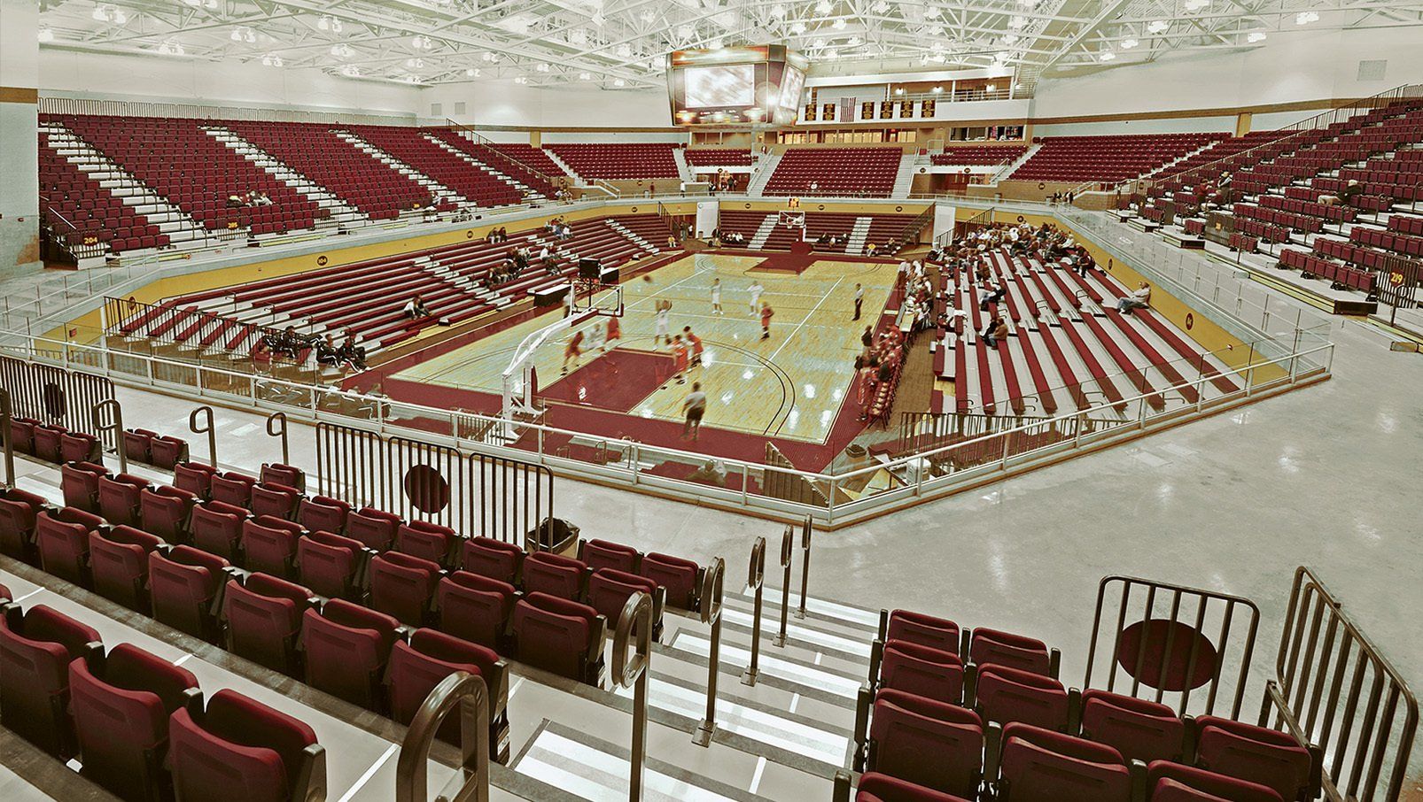Burgundy Interkal Contour Seat Modules and VISION Platform Chairs on display at the basketball court at Calvin University.