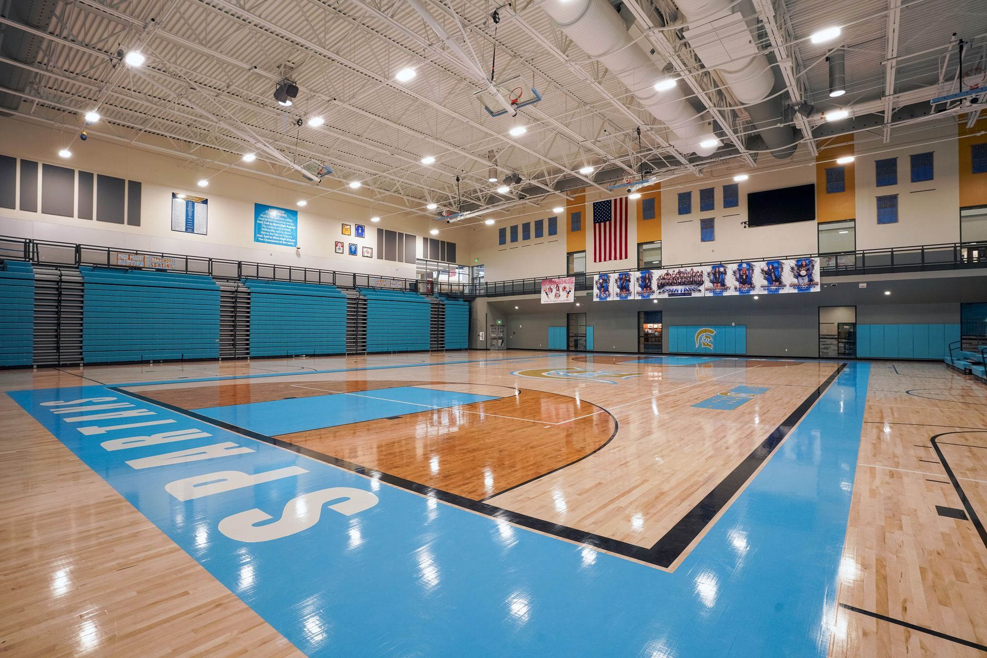 EXCEL seating modules in a custom teal on the telescopic bleachers at Greeley West High School.