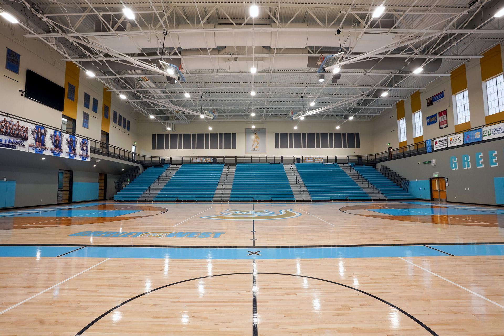 EXCEL seating modules in a custom teal on the telescopic bleachers at Greeley West High School.