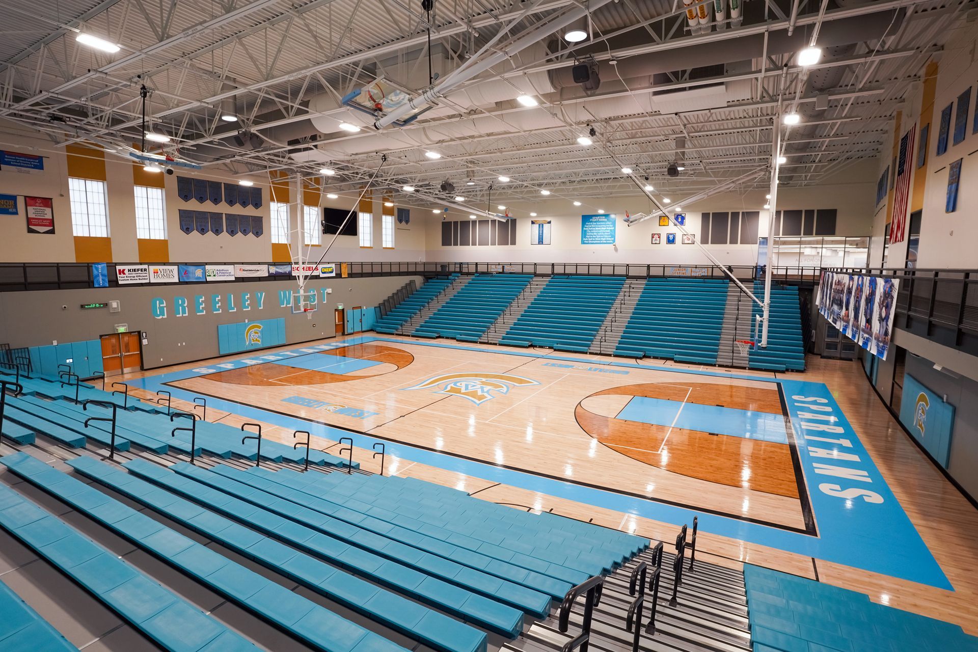 EXCEL seating modules in a custom teal on the telescopic bleachers at Greeley West High School.