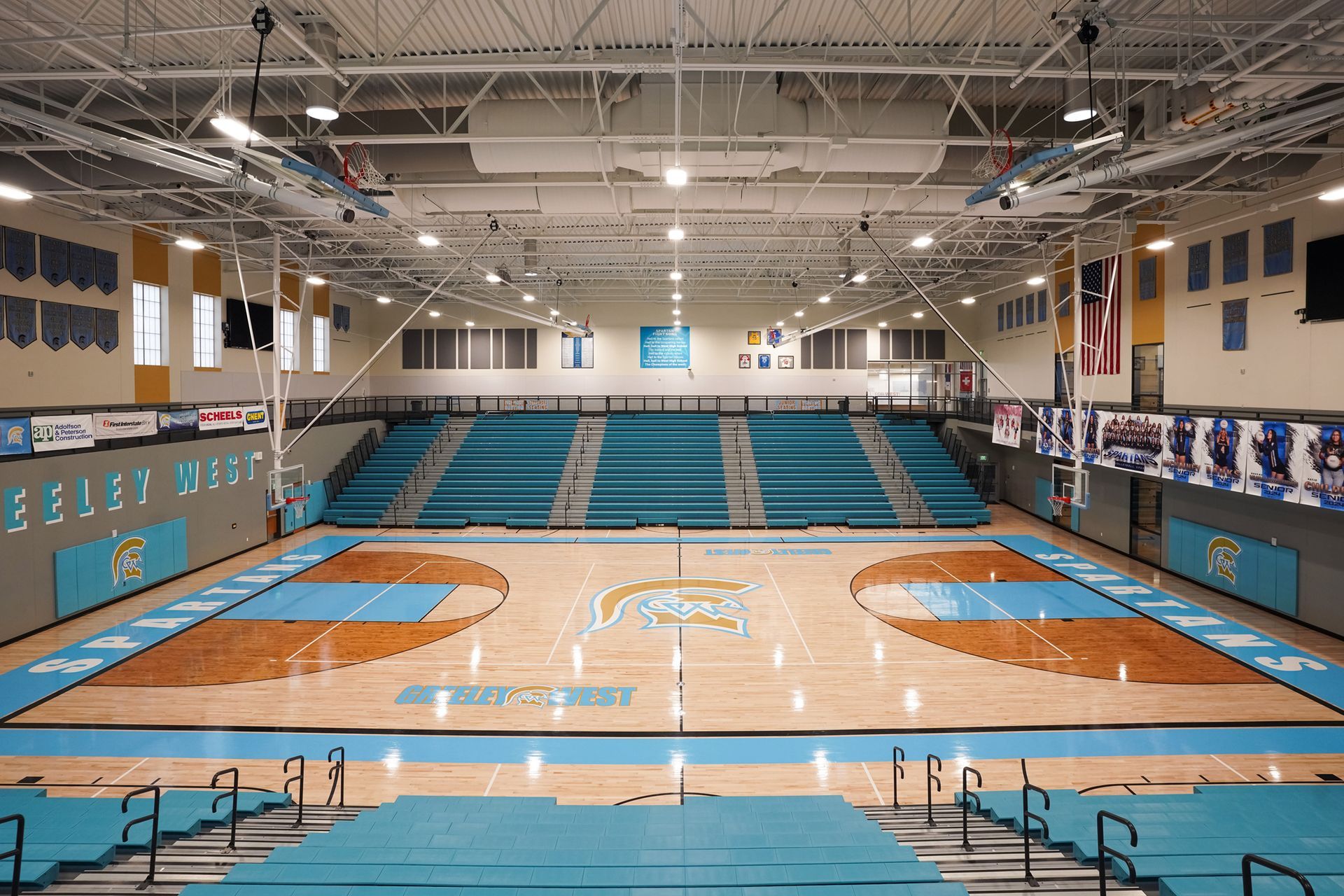 EXCEL seating modules in a custom teal on the telescopic bleachers at Greeley West High School.