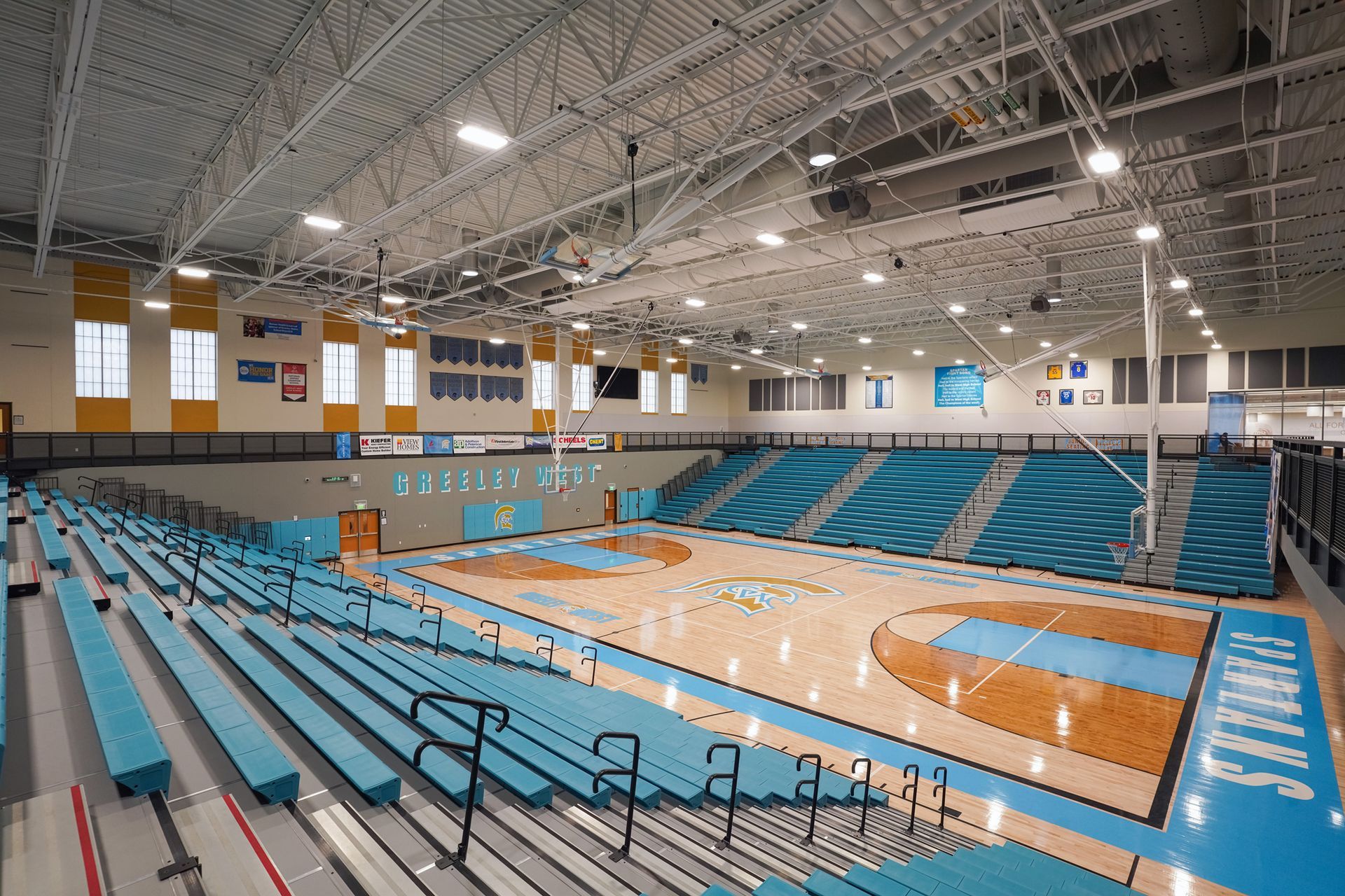 EXCEL seating modules in a custom teal on the telescopic bleachers at Greeley West High School.
