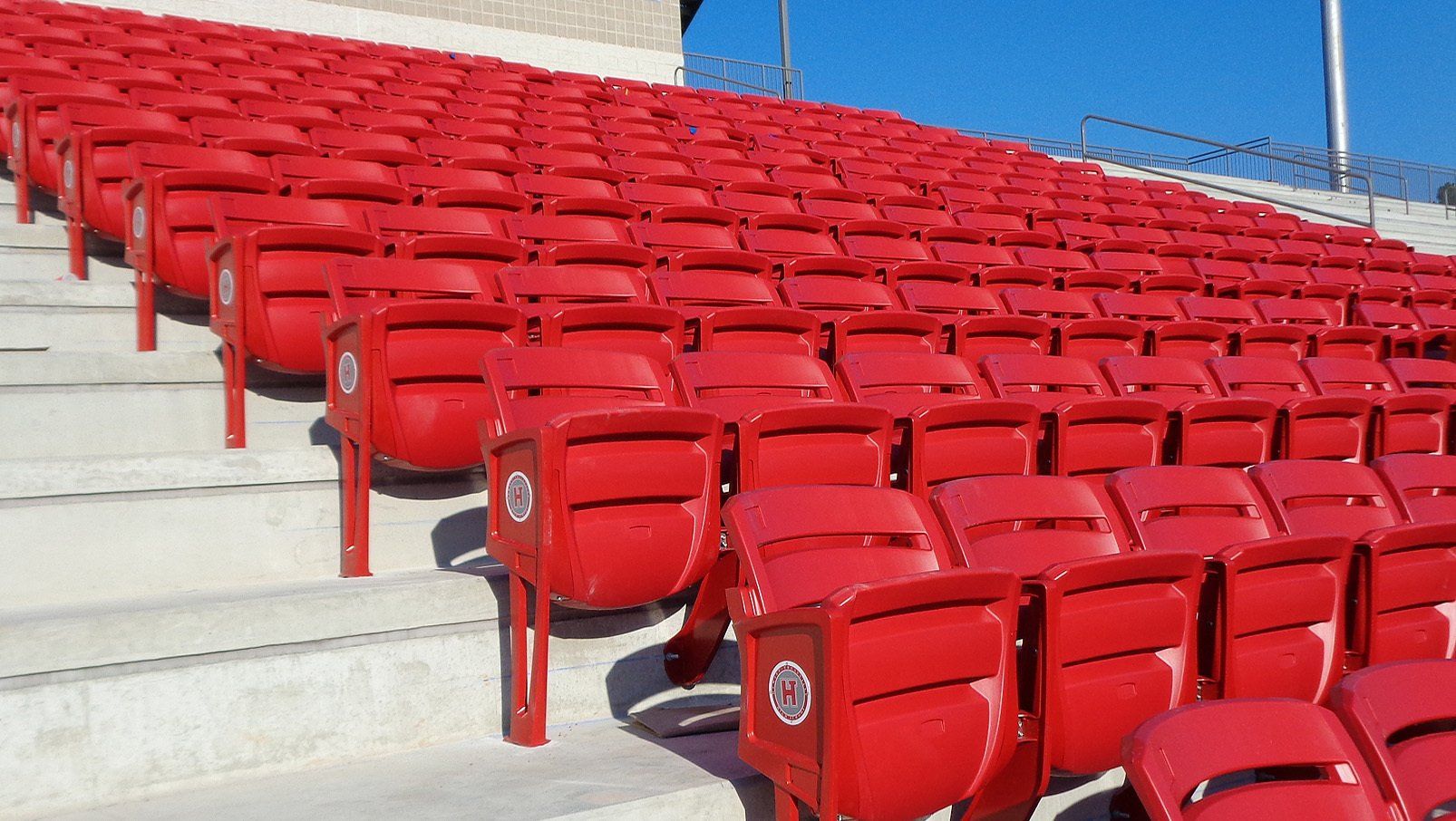 Red Interkal AURA Slat Stadium Chairs adorn the alumni section of the Hewitt-Trussville High School football stadium.