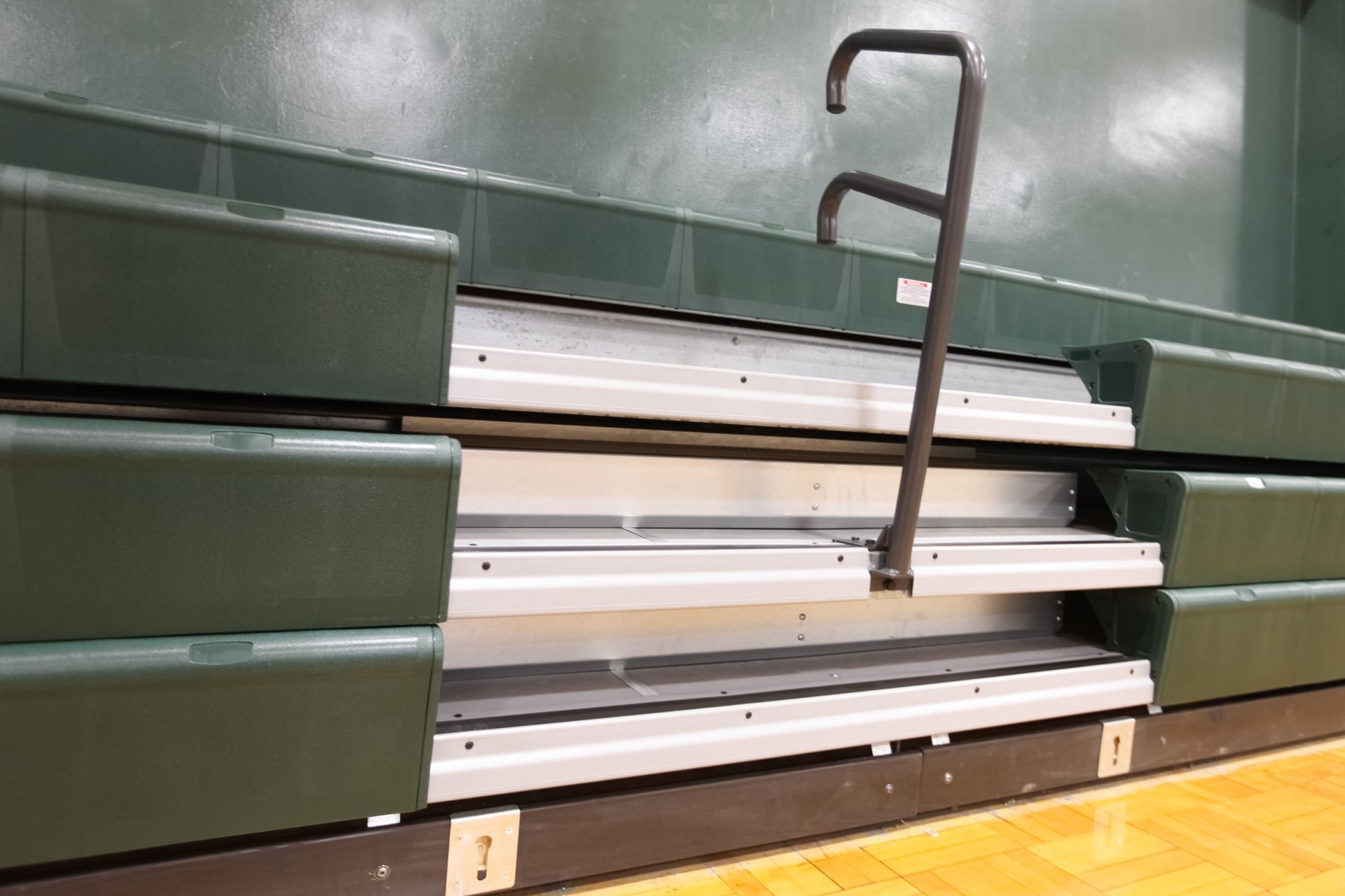 Renovated telescopic bleachers with EXCEL Seat Modules and Self-Storing Aisle Rails at the Holy Name Catholic School gym.