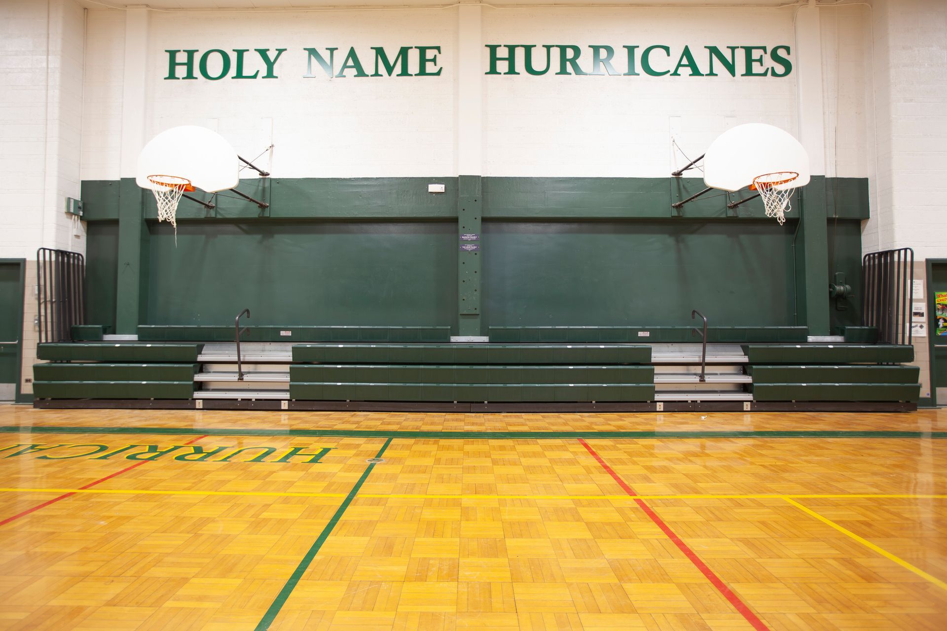 Renovated telescopic bleachers with EXCEL Seat Modules and Self-Storing Aisle Rails at the Holy Name Catholic School gym.