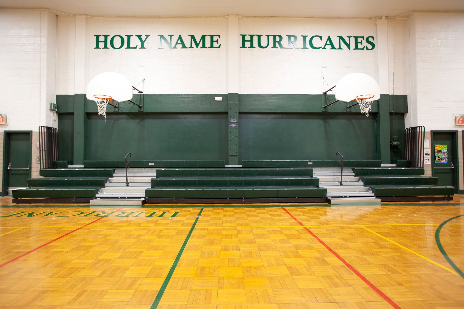 Renovated telescopic bleachers with EXCEL Seat Modules and Self-Storing Aisle Rails at the Holy Name Catholic School gym.