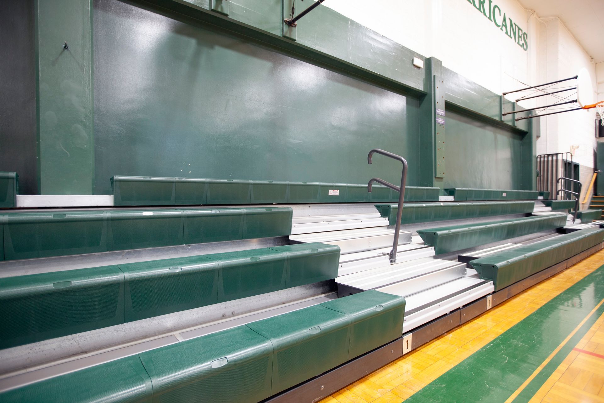 Renovated telescopic bleachers with EXCEL Seat Modules and Self-Storing Aisle Rails at the Holy Name Catholic School gym.