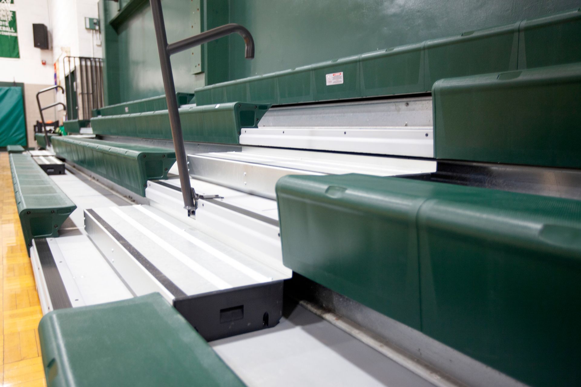 Renovated telescopic bleachers with EXCEL Seat Modules and Self-Storing Aisle Rails at the Holy Name Catholic School gym.