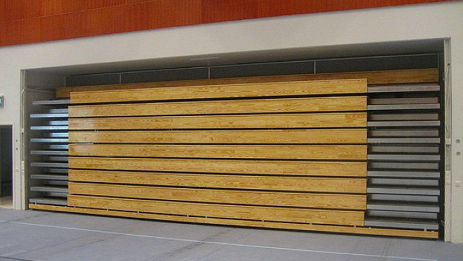 Interkal Classic wood bleachers in a recessed operation adorn the gymnasium in Huutjarvi, Finland.