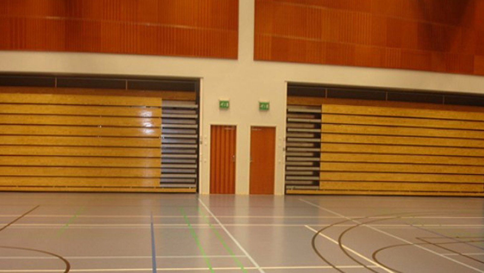 Interkal Classic wood bleachers in a recessed operation adorn the gymnasium in Huutjarvi, Finland.