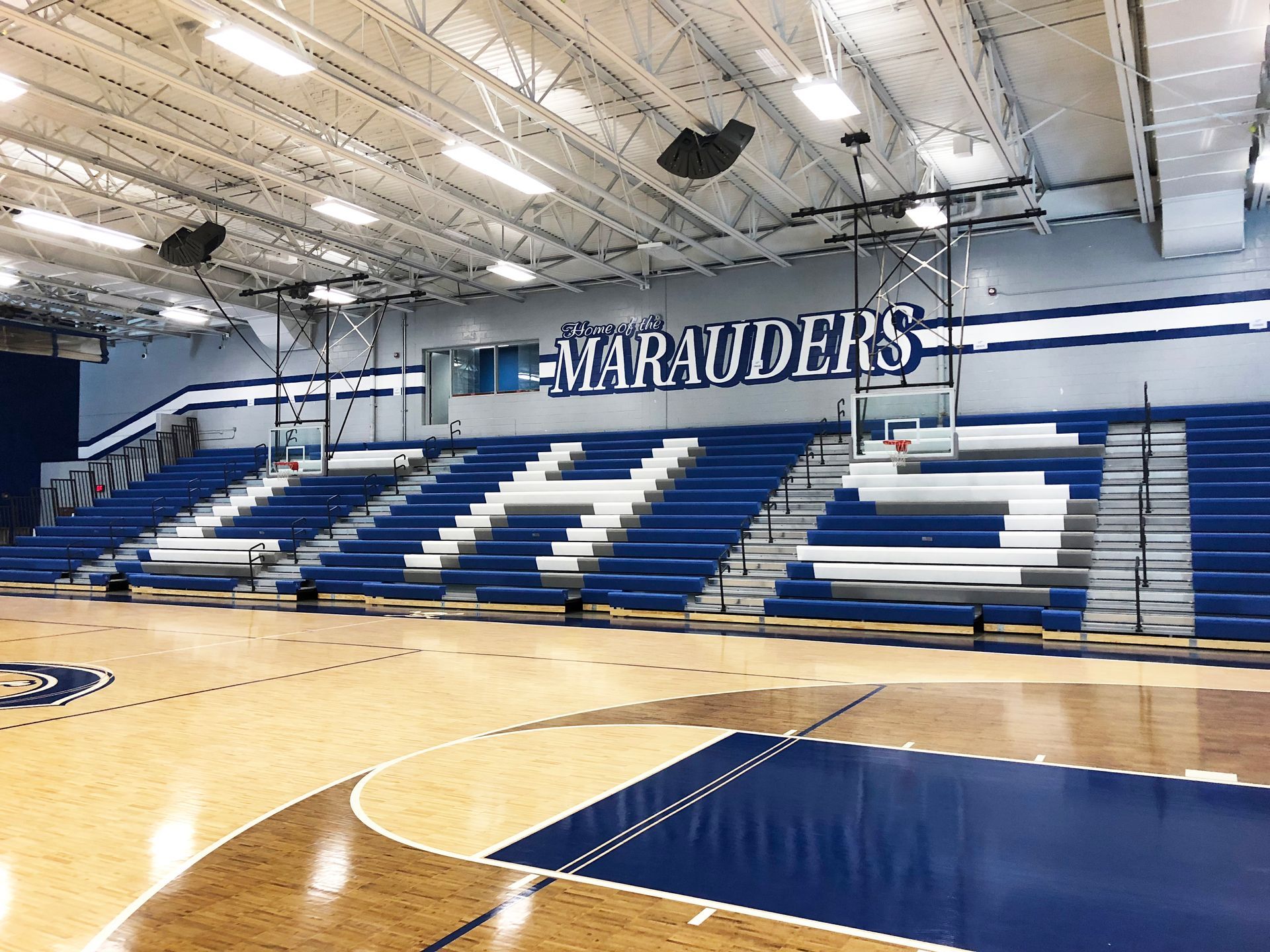 EXCEL Seat Modules in blue and white, spelling out CHS on the telescopic platform at the basketball gymnasium.