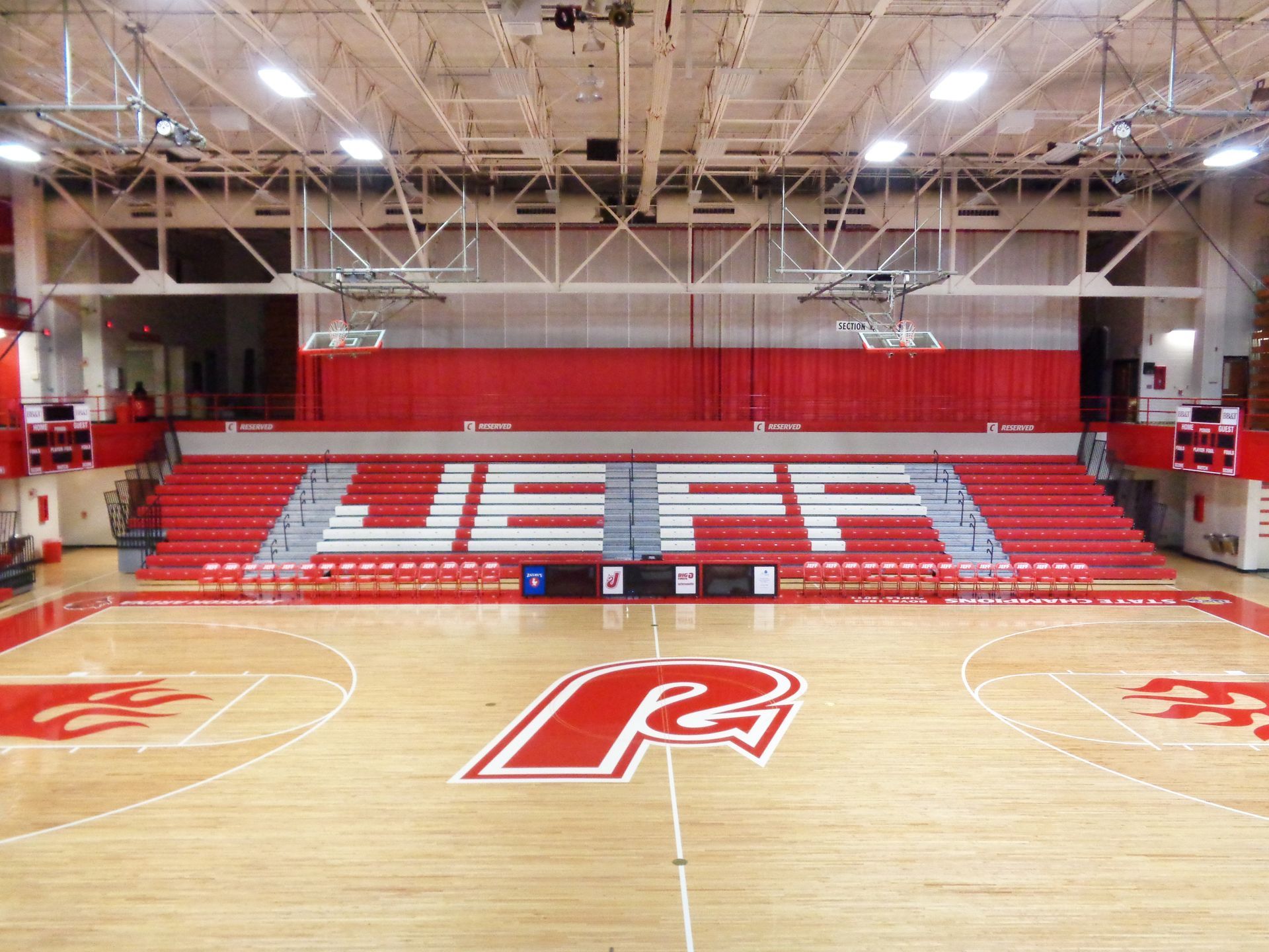 Excel Seat Modules in red and white, to spell out the high school name on the telescopic bleacher system when open or closed.