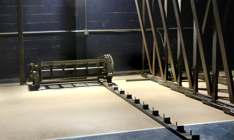 A wide shot of the Interkal non-friction power option, set against the wall underneath the telescopic bleacher system.