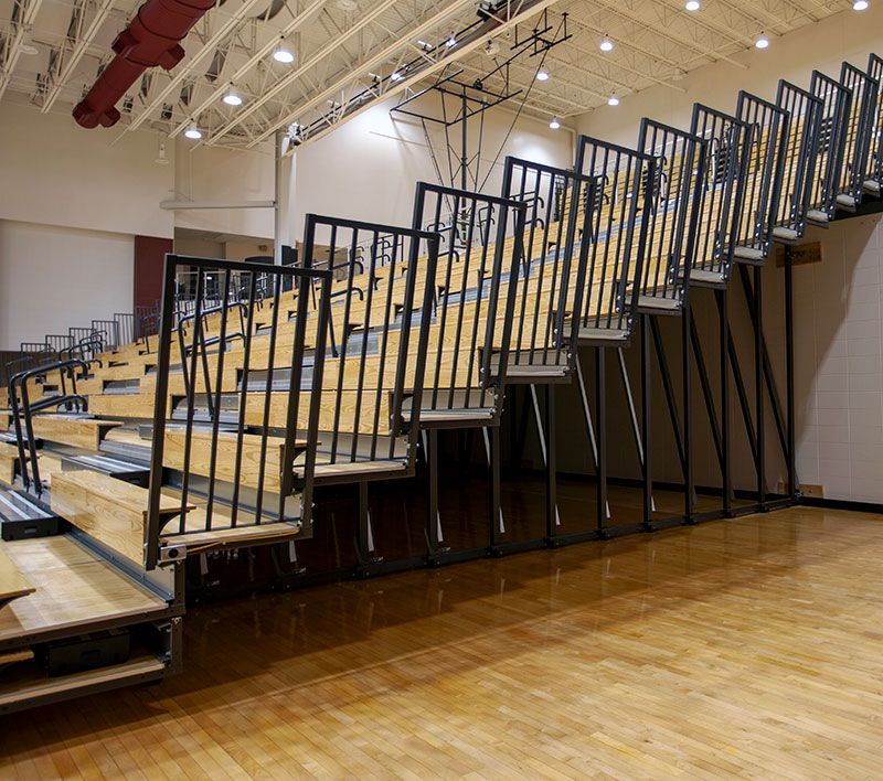 Self-Storing End Rails on Telescopic Bleachers