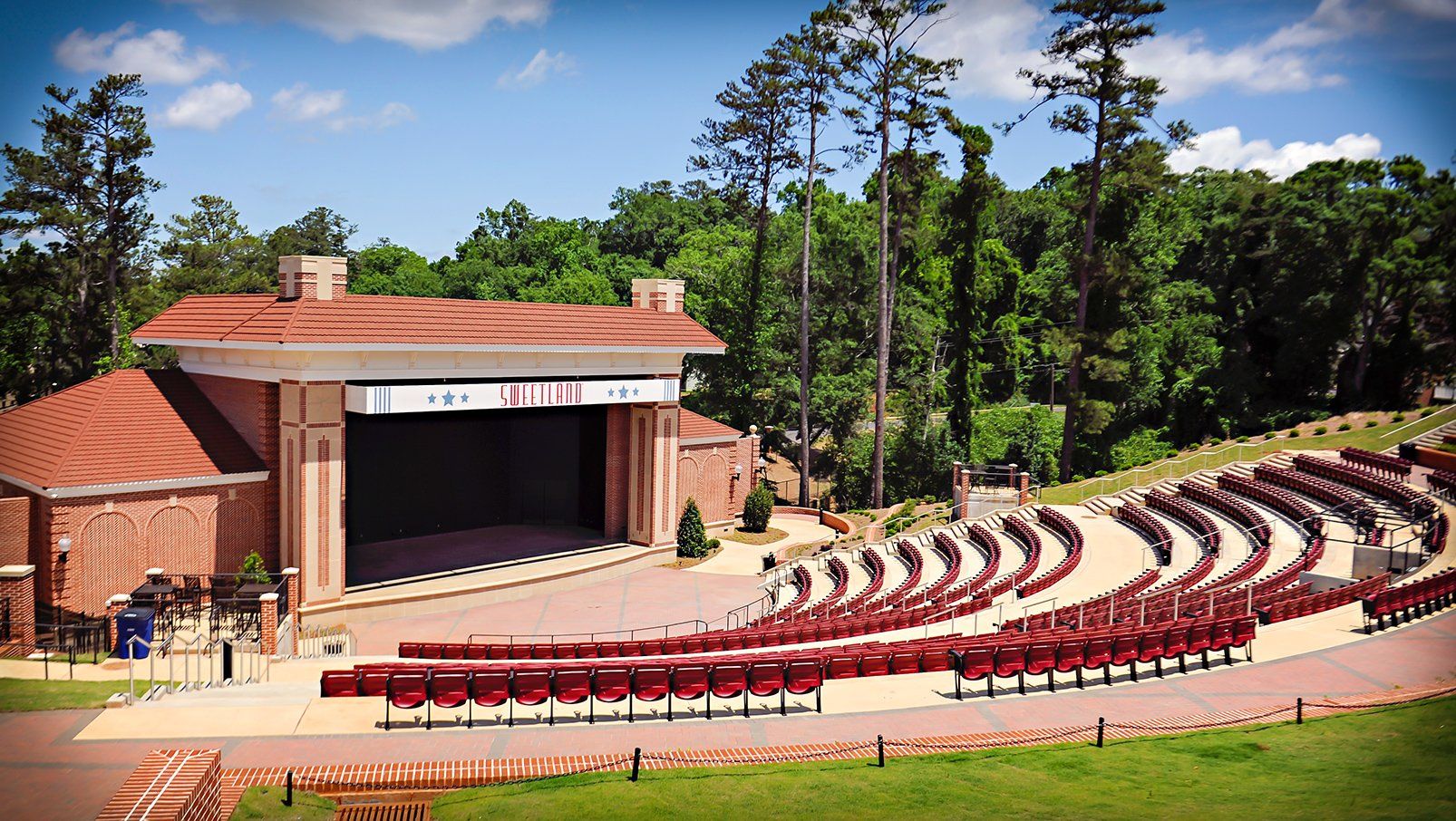 Burgundy Interkal AURA Slat Stadium Chairs with armrests with cupholders in the outdoor amphitheater at Boyd Sweetland.