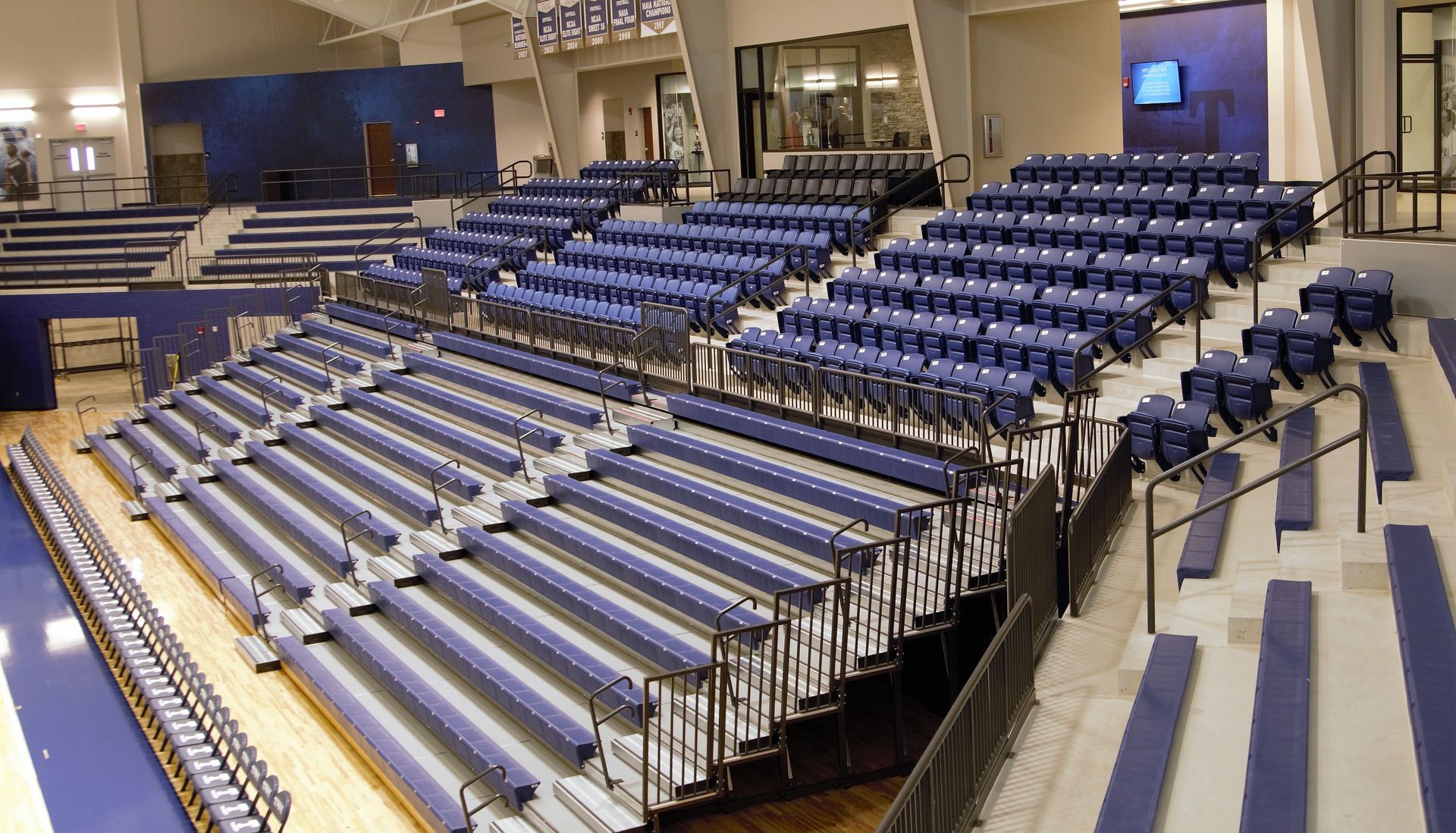 Blue EXCEL Seat Modules on a telescopic system with VISION Platform Seating above, on a fixed platform.