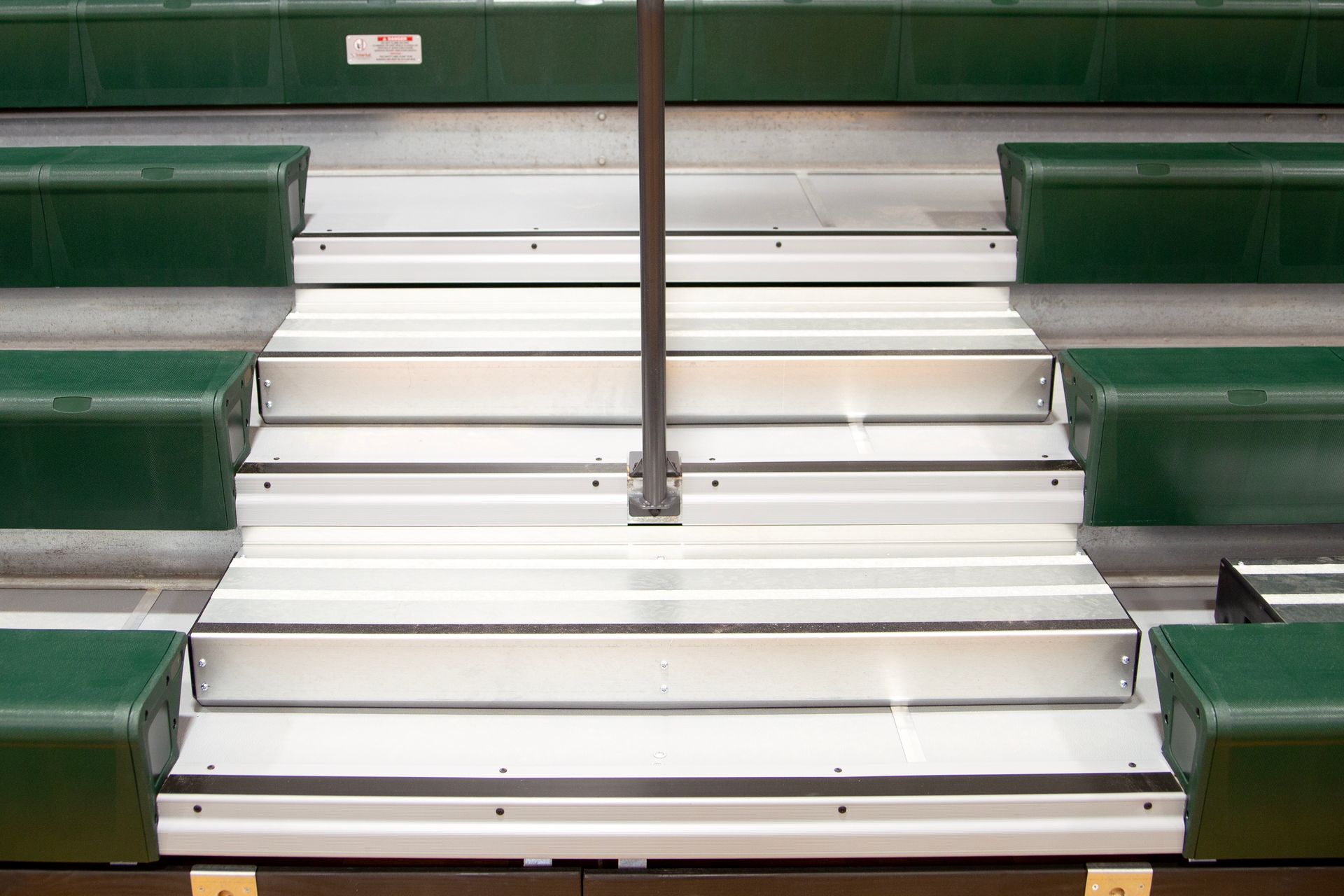 Renovated telescopic bleachers with EXCEL Seat Modules and Self-Storing Aisle Rails at the Holy Name Catholic School gym.