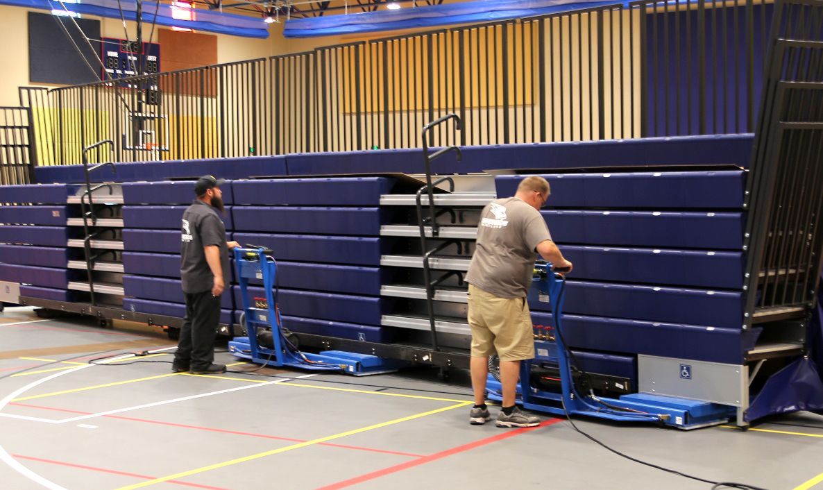 The air pallet in use, moving a mobile bleacher section into position at Kirtland College.