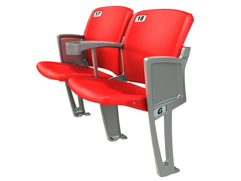 Three-quarter shot of the Interkal AURA Solid Stadium Chair with side stanchions and armrest with cupholders.