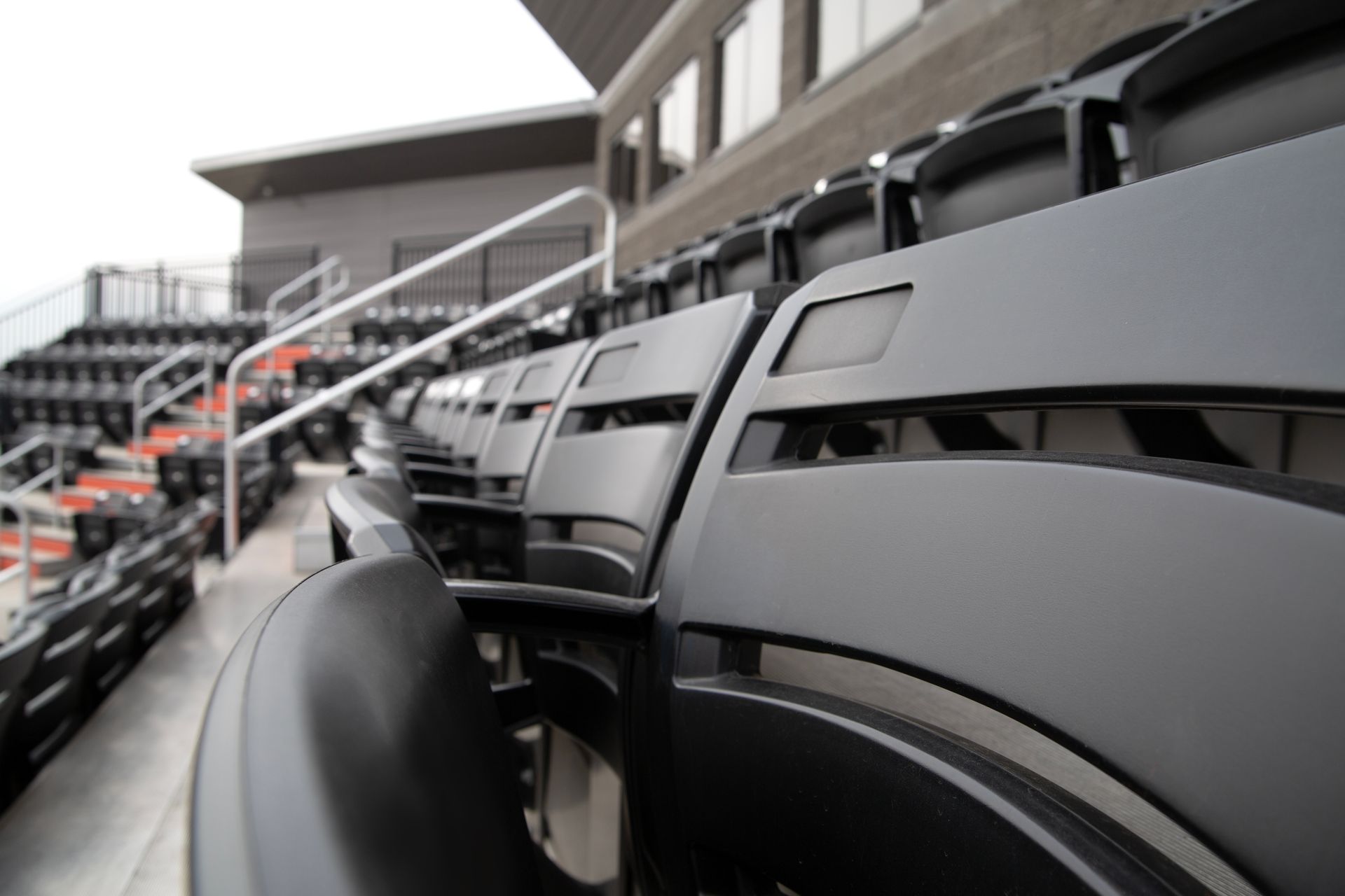 Black Interkal AURA Slat Stadium chairs in the bullpen area at the Brother Rice Warrior Park, in Michigan.