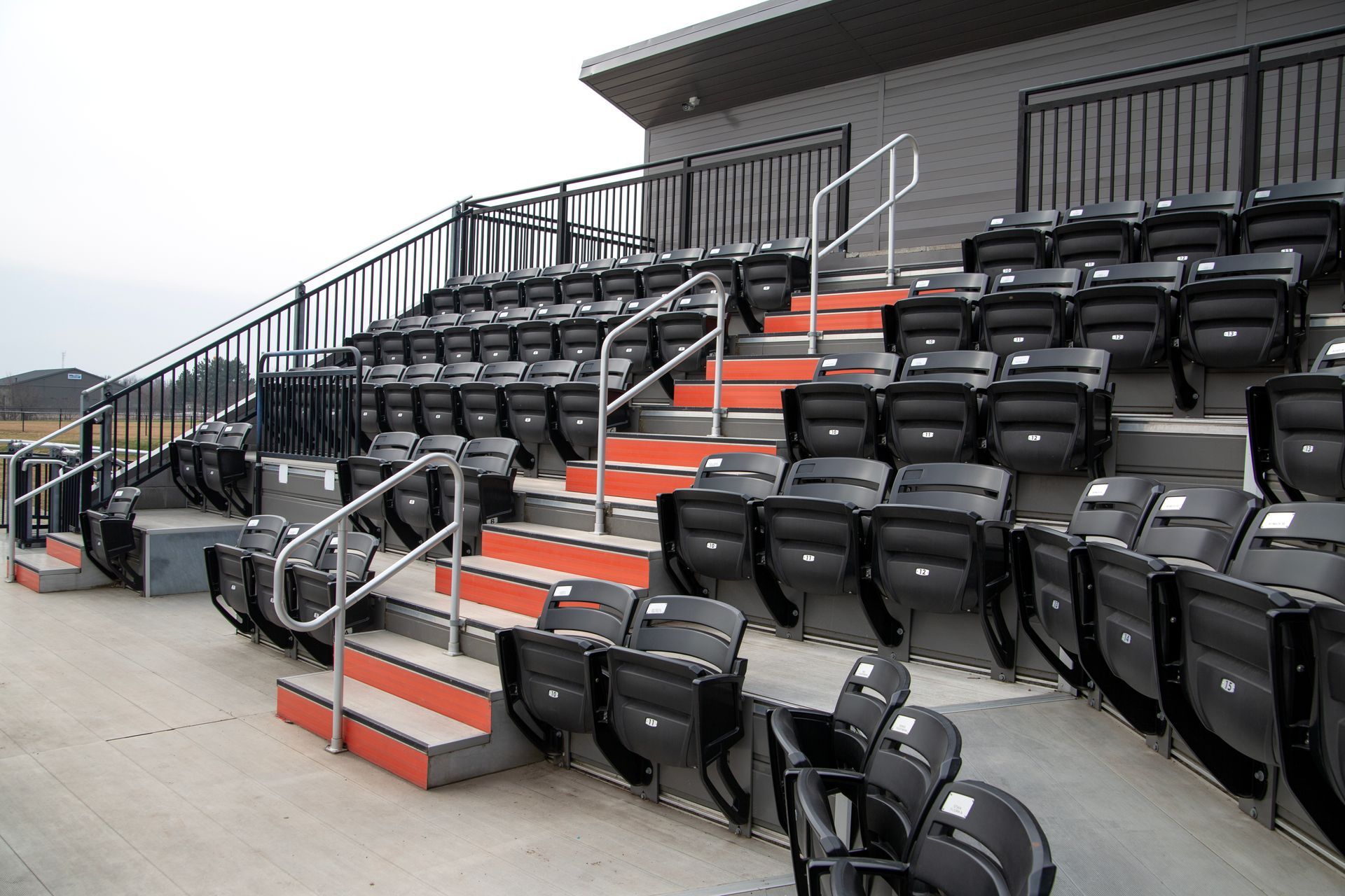Black Interkal AURA Slat Stadium chairs in the bullpen area at the Brother Rice Warrior Park, in Michigan.