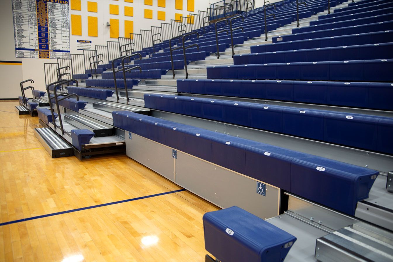 Blue Interkal EXCEL Seat Modules color the massive high-rise telescopic bleacher installation at the Dewitt High School gym.