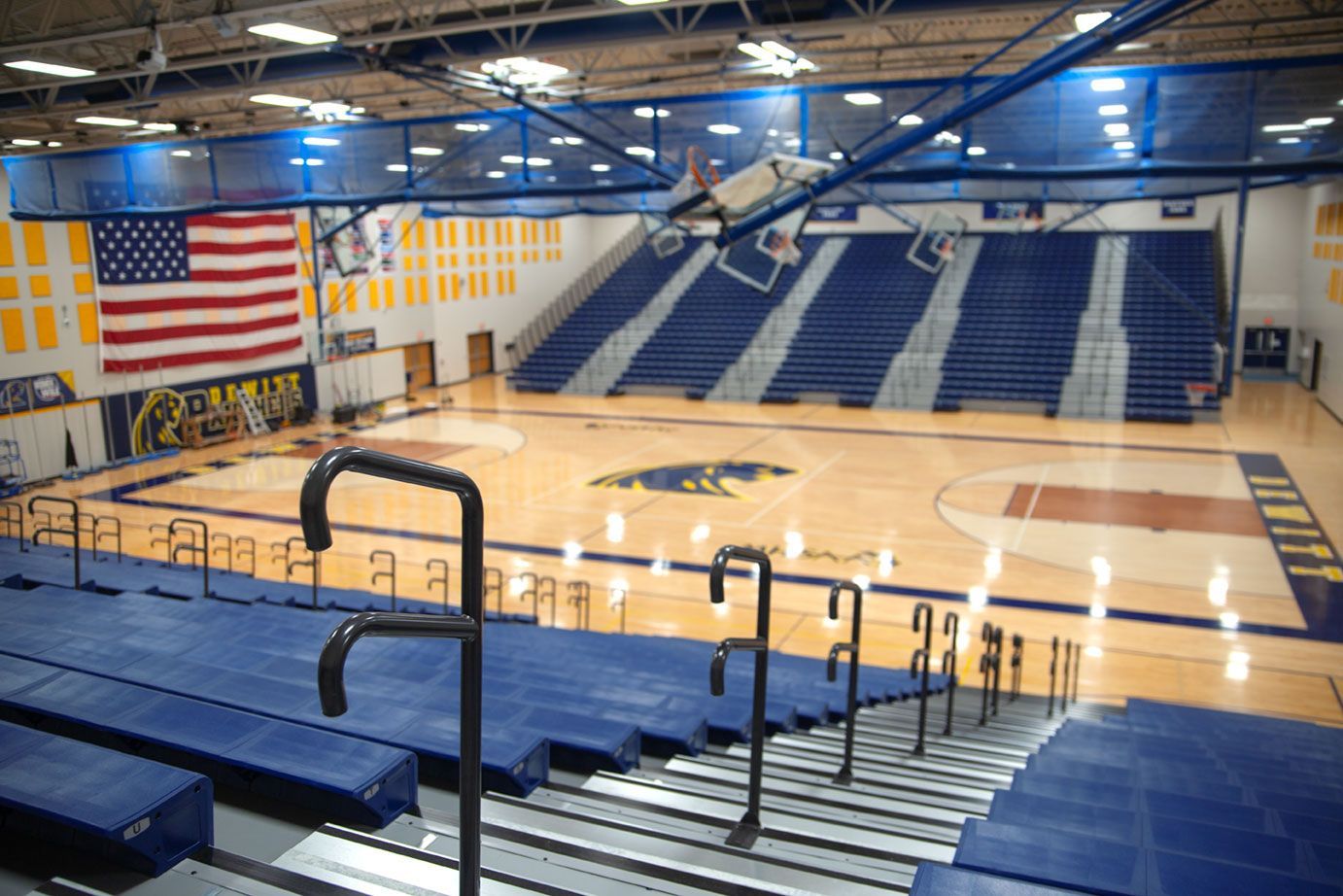 Blue Interkal EXCEL Seat Modules color the massive high-rise telescopic bleacher installation at the Dewitt High School gym.