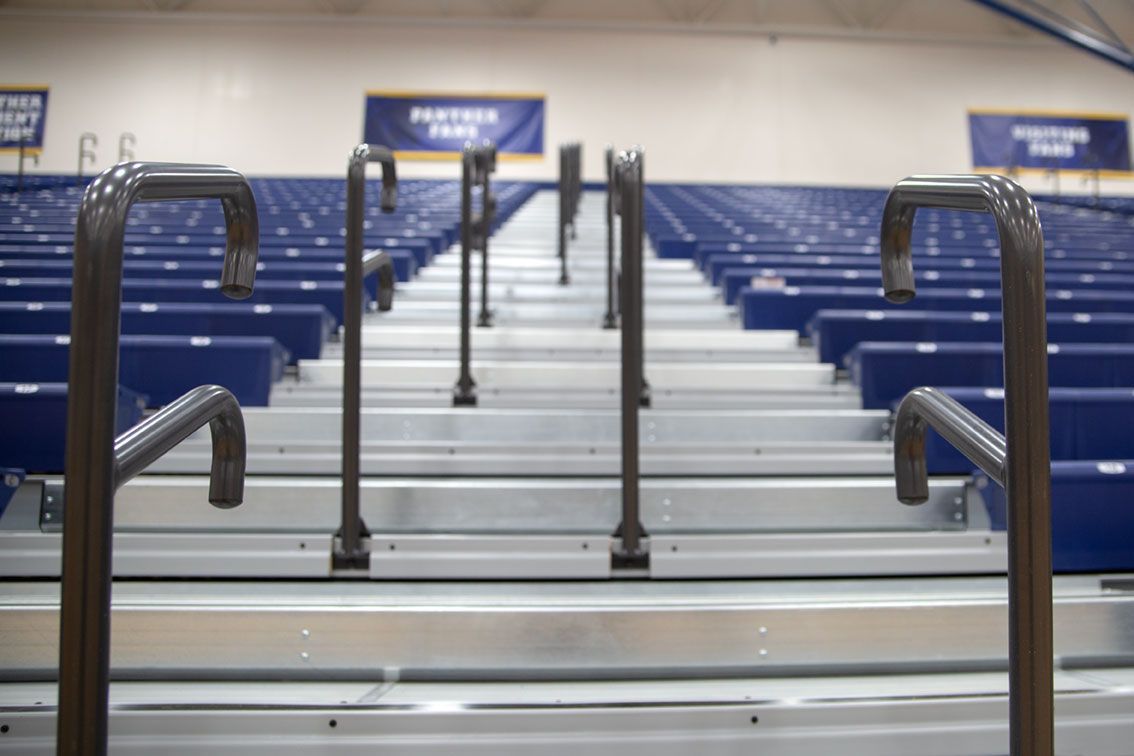 Blue Interkal EXCEL Seat Modules color the massive high-rise telescopic bleacher installation at the Dewitt High School gym.