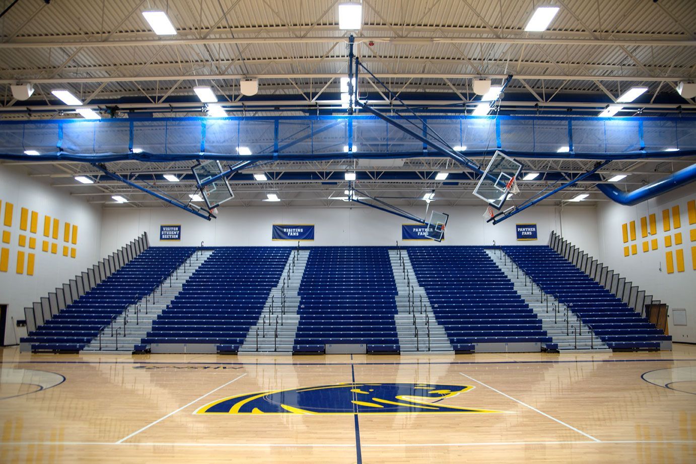 Blue Interkal EXCEL Seat Modules color the massive high-rise telescopic bleacher installation at the Dewitt High School gym.