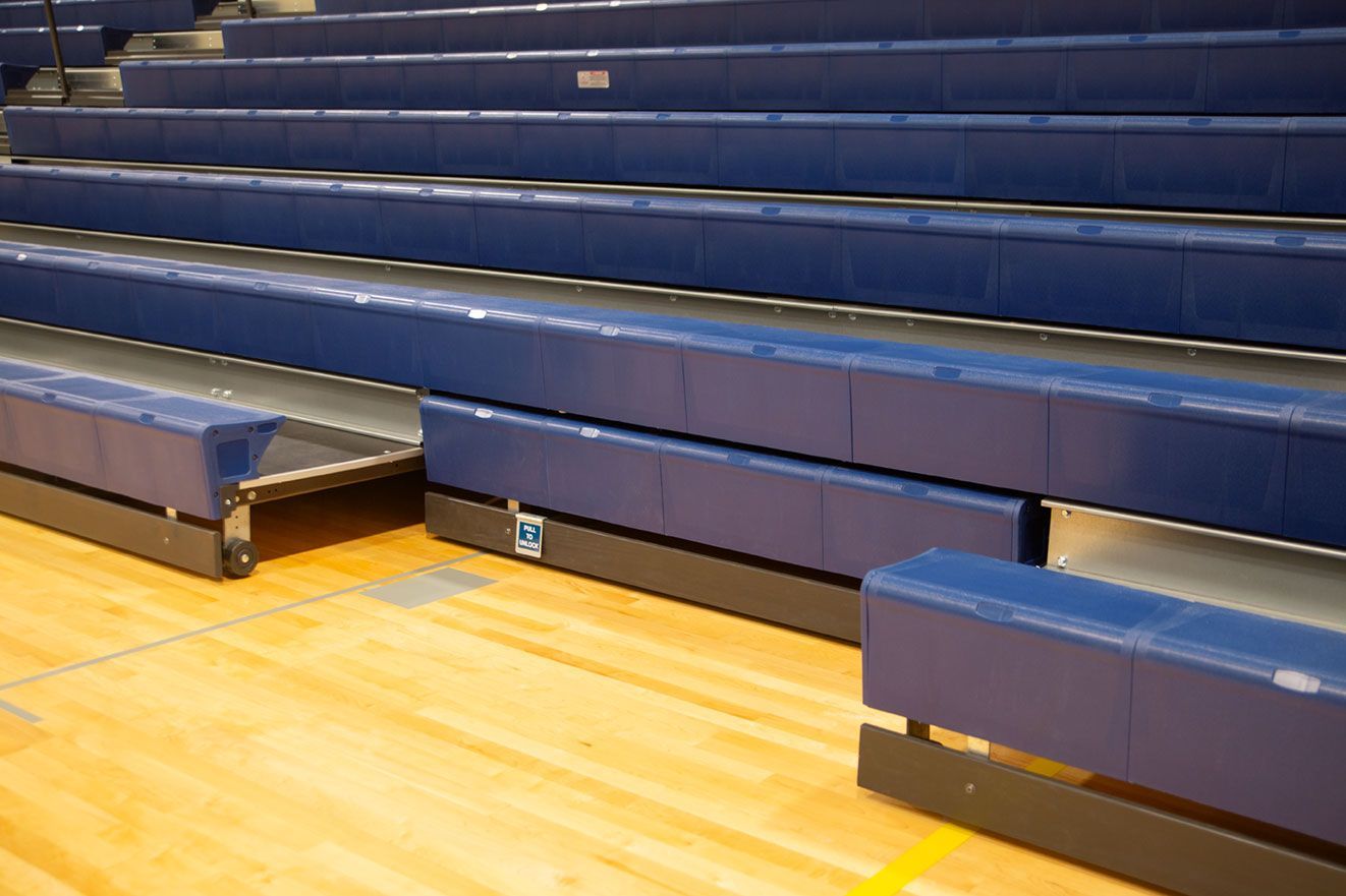 The gymnasium at Gull Lake Middle School, featuring Blackout B1 tier with blue EXCEL seat modules, self-storing aisle rails.