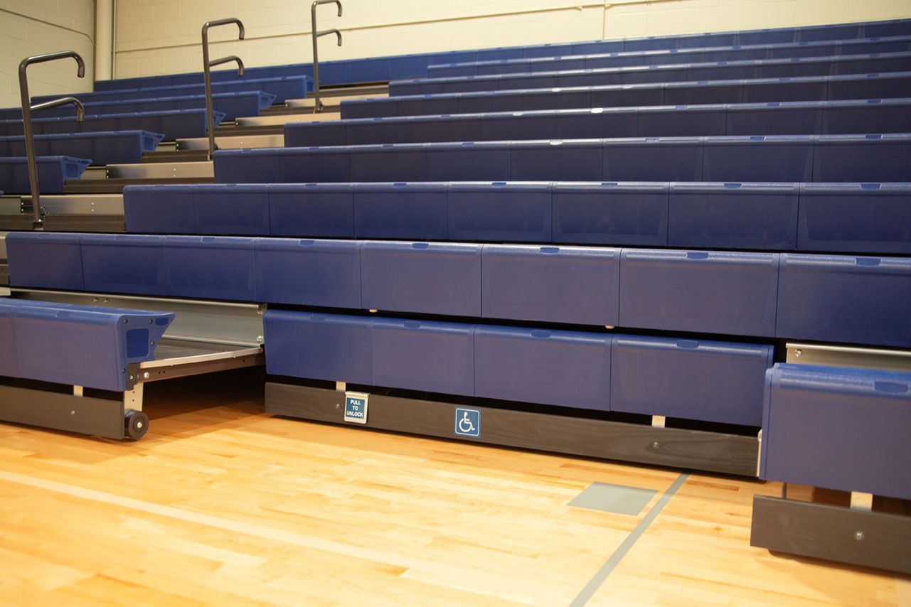 The gymnasium at Gull Lake Middle School, featuring Blackout B1 tier with blue EXCEL seat modules, self-storing aisle rails.
