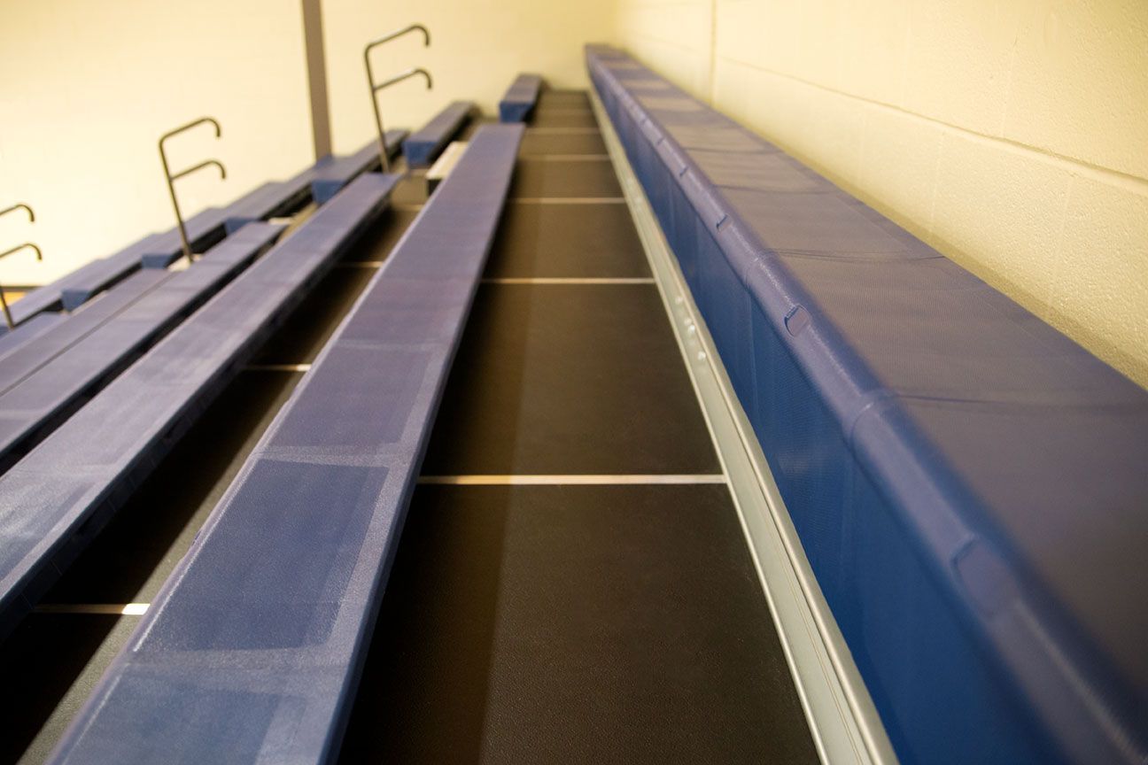 The gymnasium at Gull Lake Middle School, featuring Blackout B1 tier with blue EXCEL seat modules, self-storing aisle rails.
