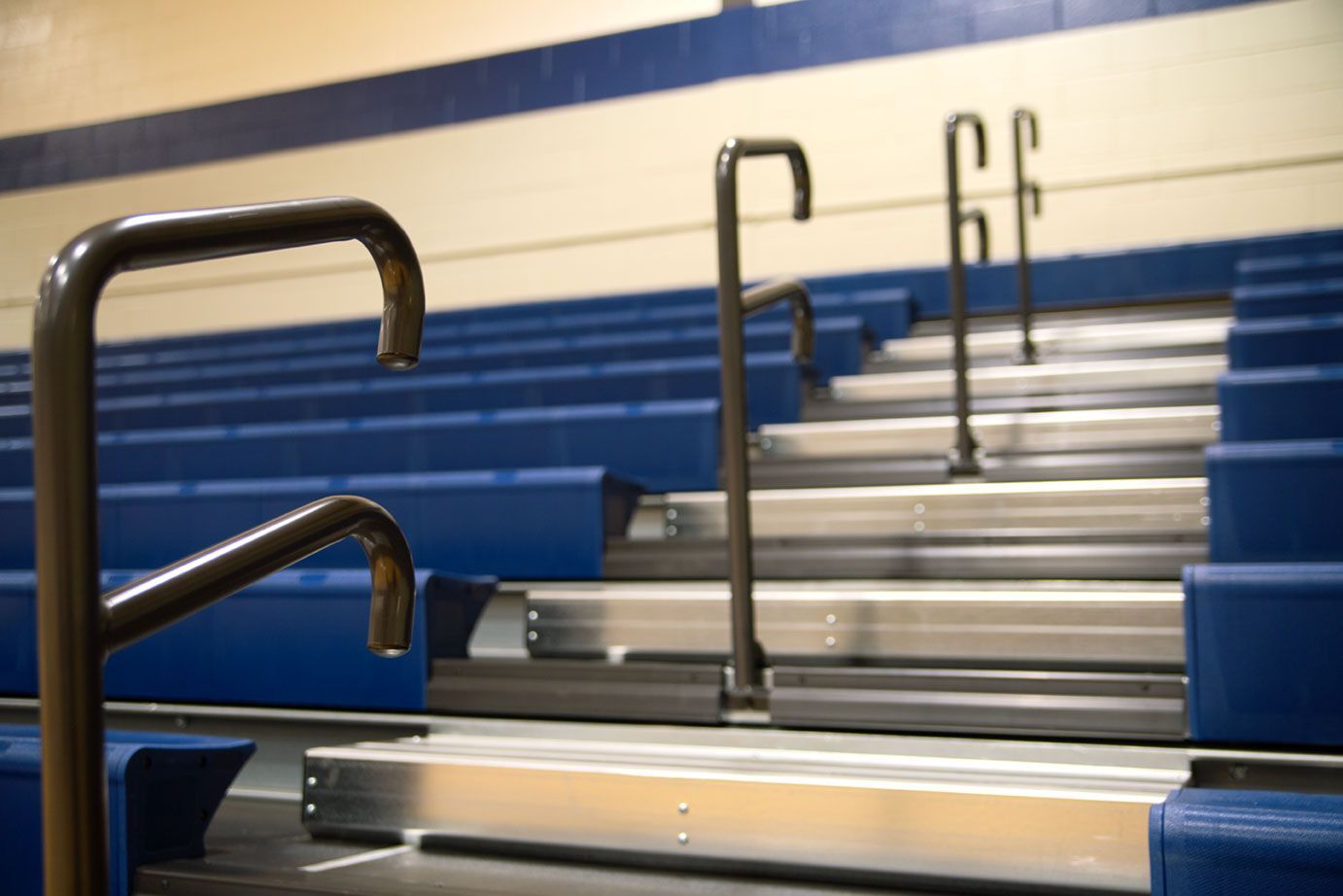 The gymnasium at Gull Lake Middle School, featuring Blackout B1 tier with blue EXCEL seat modules, self-storing aisle rails.