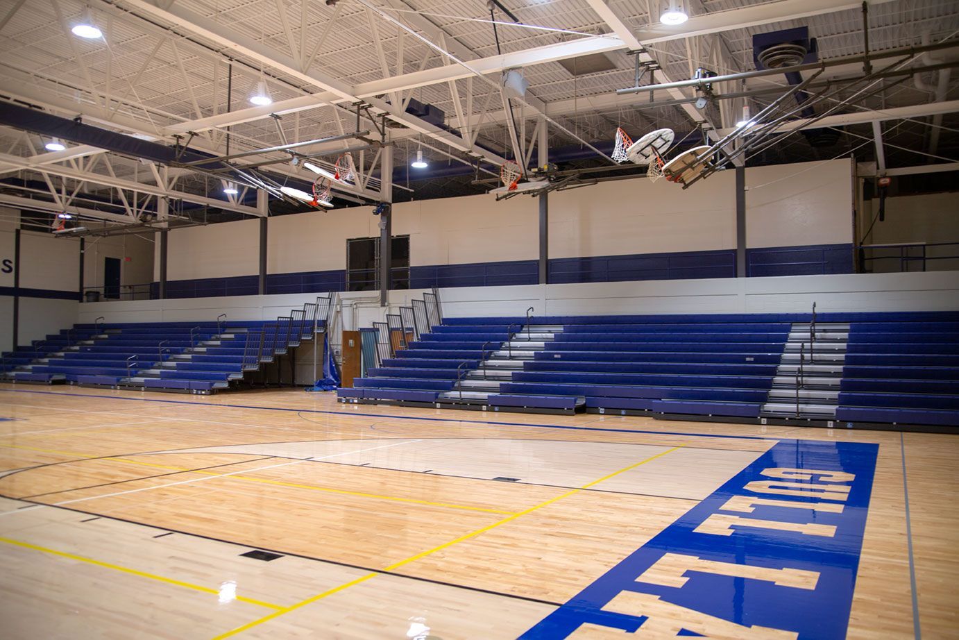 The gymnasium at Gull Lake Middle School, featuring Blackout B1 tier with blue EXCEL seat modules, self-storing aisle rails.