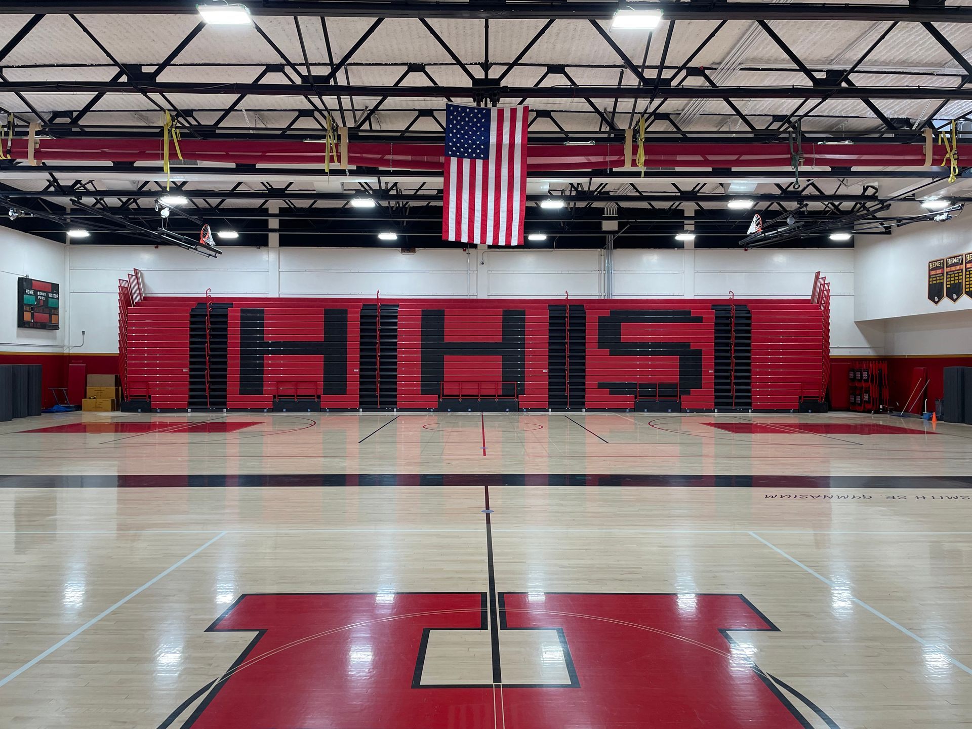The telescopic bleacher system at Hemet High School in California, featuring custom red aisle rails and school initials.