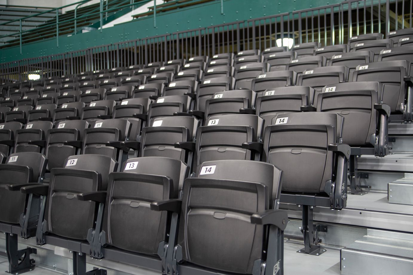 VISION Platform Chairs with armrests on a mobile Wide Deck Premier Platform system at Michigan State's Jenison Field House.