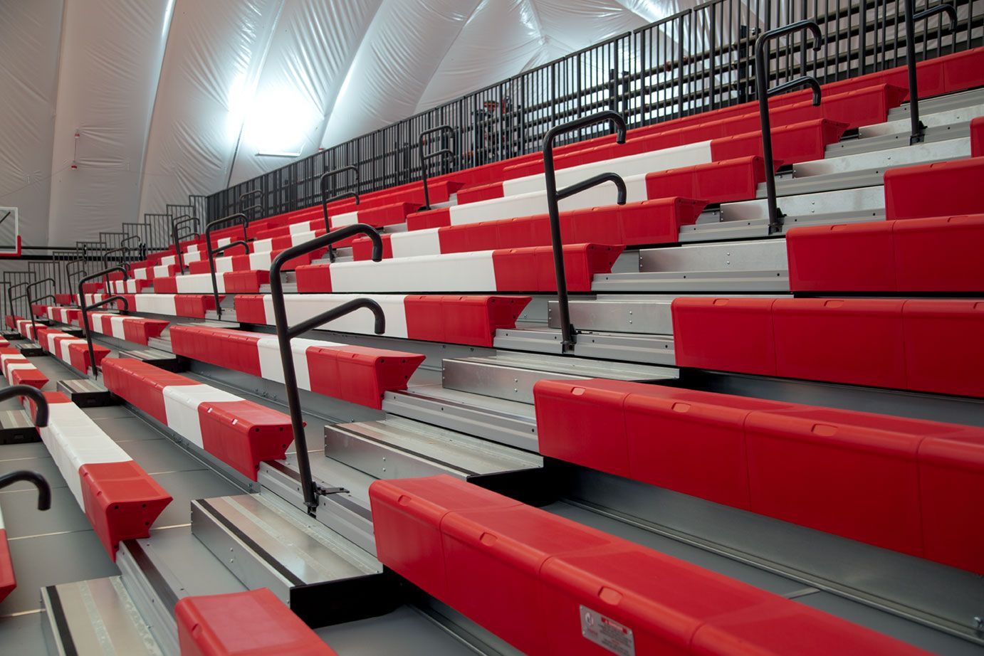 The telescopic bleacher system at the Melvindale High School dome, in Michigan, which features white school initials.