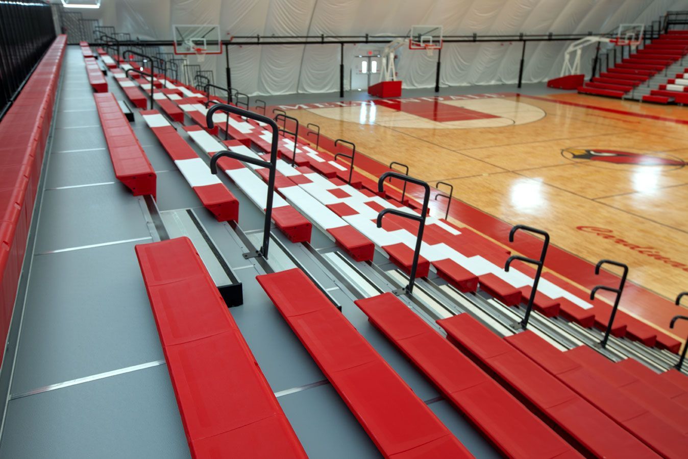 The telescopic bleacher system at the Melvindale High School dome, in Michigan, which features white school initials.