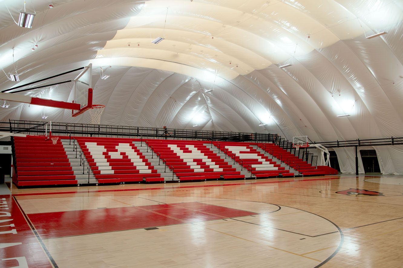 The telescopic bleacher system at the Melvindale High School dome, in Michigan, which features white school initials.