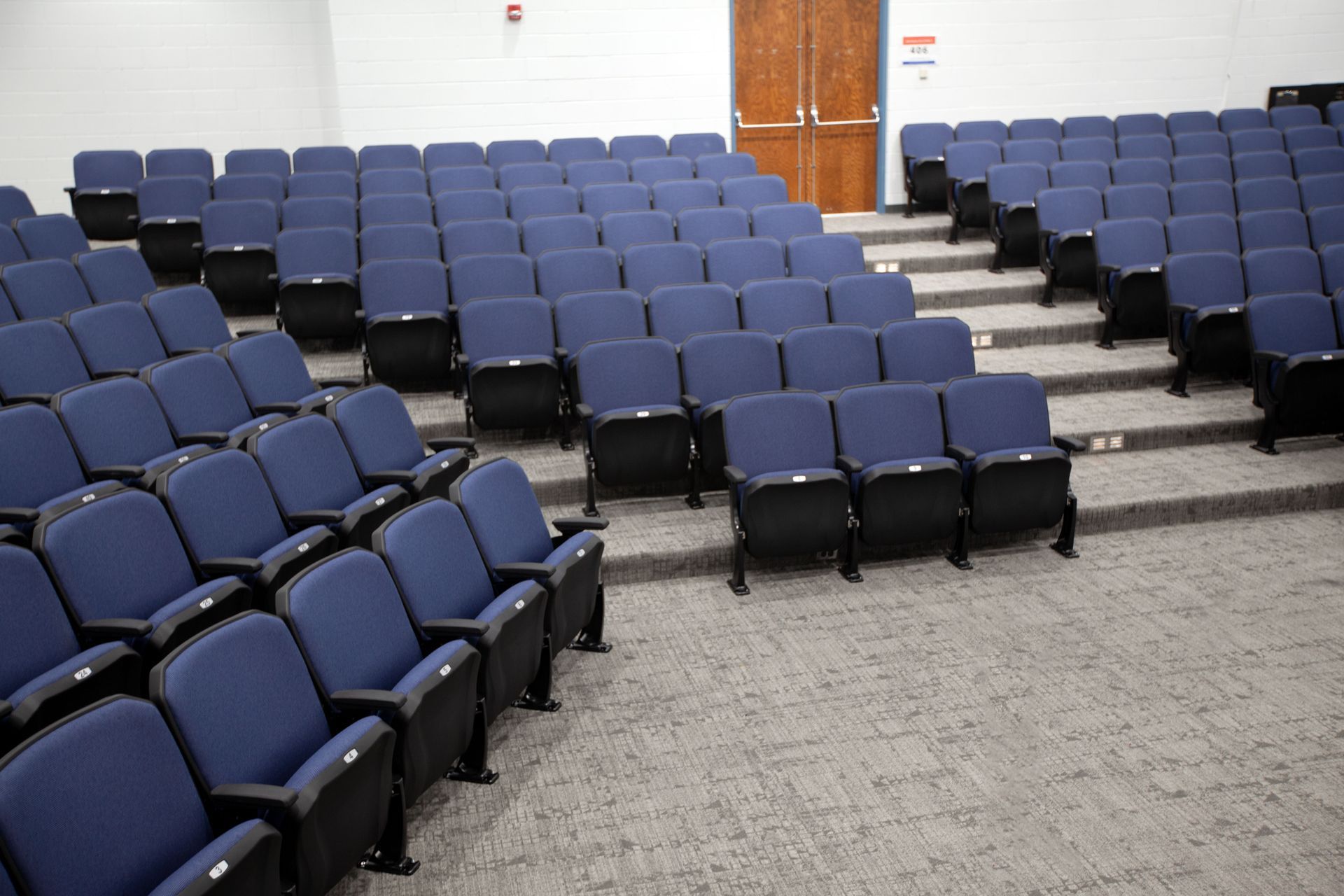 The auditorium at Sundling Junior High, with ODYSSEY Auditorium Chairs with molded armrests, blue upholstery, seat numbers.