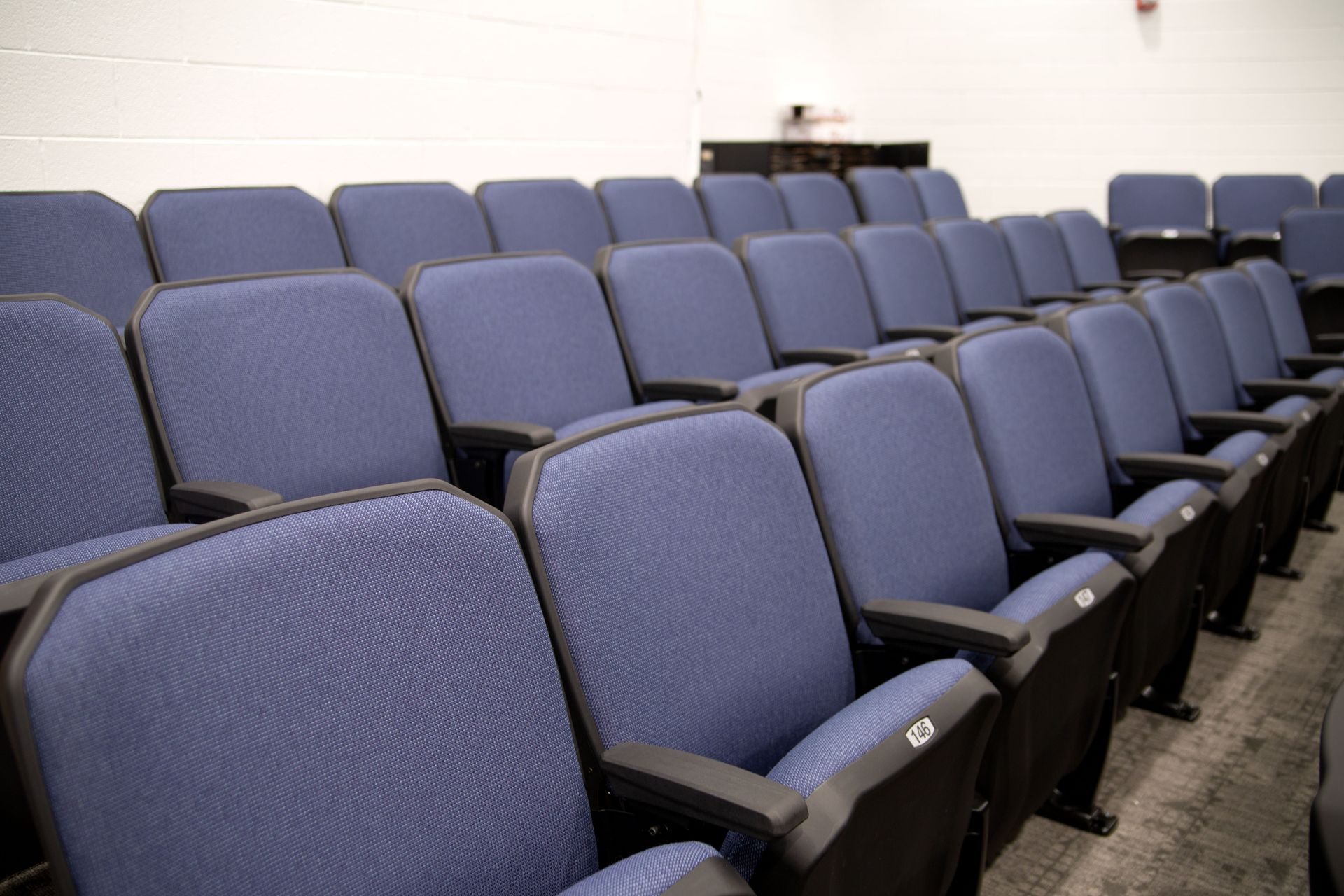 The auditorium at Sundling Junior High, with ODYSSEY Auditorium Chairs with molded armrests, blue upholstery, seat numbers.
