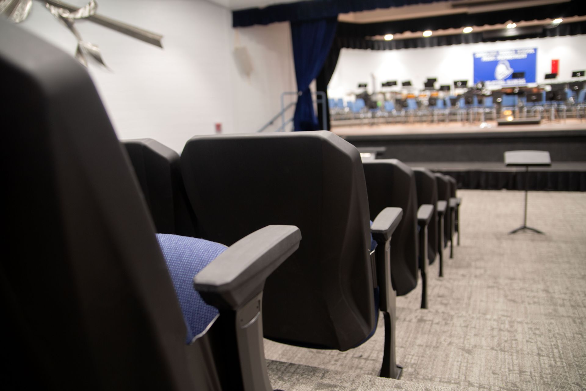 The auditorium at Sundling Junior High, with ODYSSEY Auditorium Chairs with molded armrests, blue upholstery, seat numbers.