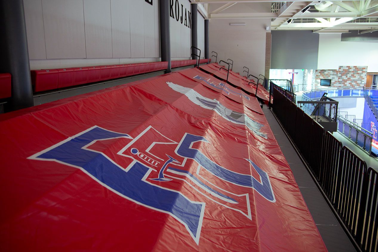 The gymnasium floor at Trojan Arena in CO that features EXCEL Seat Modules in red, white and blue colors for a striking look!