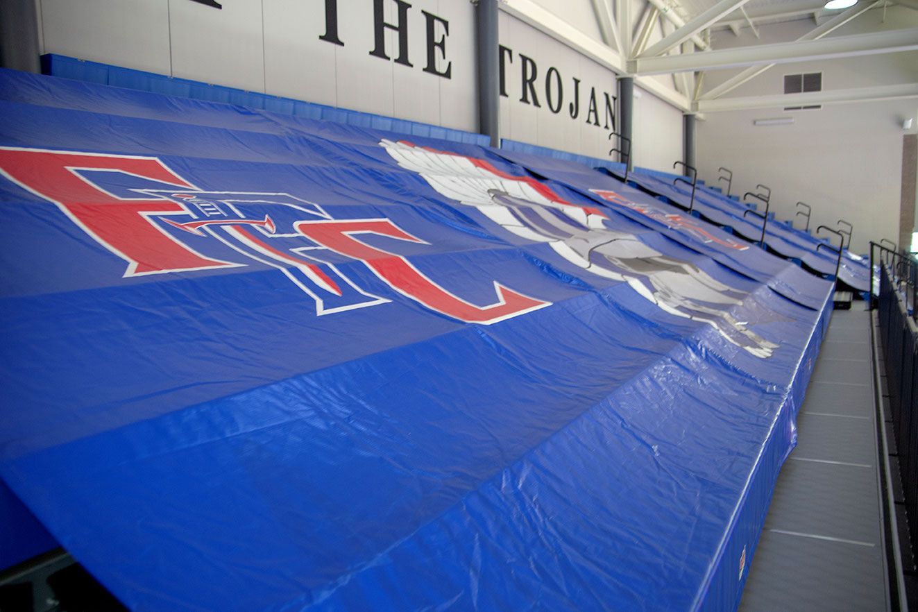 The gymnasium floor at Trojan Arena in CO that features EXCEL Seat Modules in red, white and blue colors for a striking look!