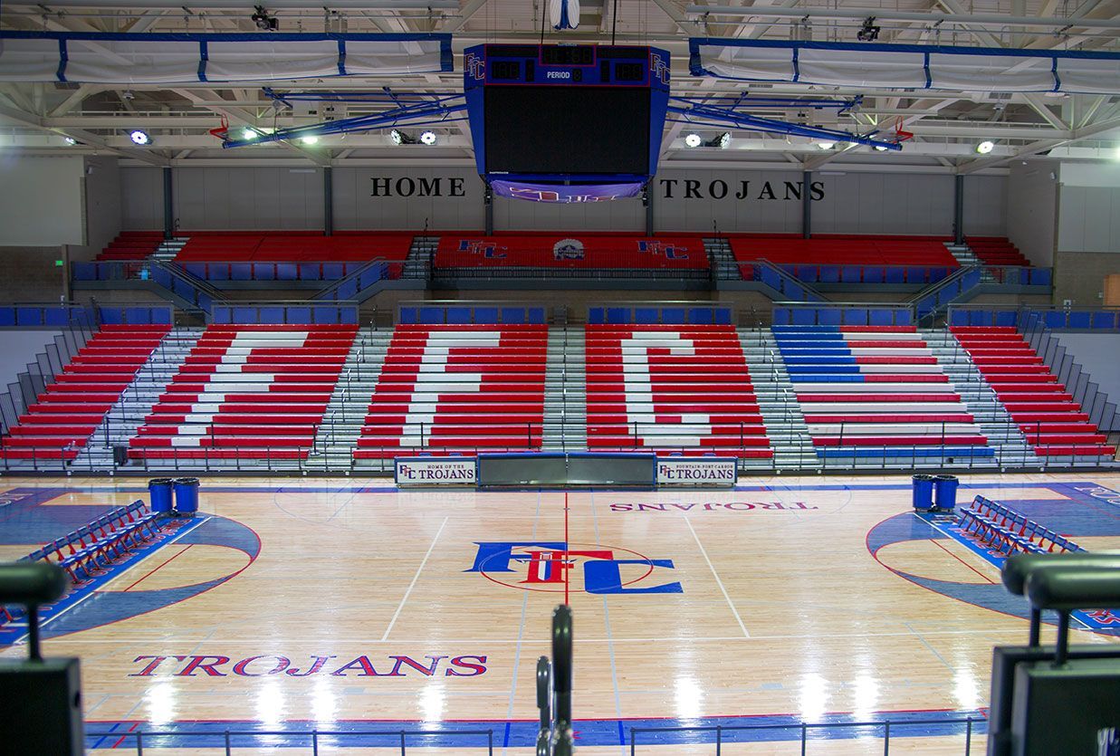 The gymnasium floor at Trojan Arena in CO that features EXCEL Seat Modules in red, white and blue colors for a striking look!