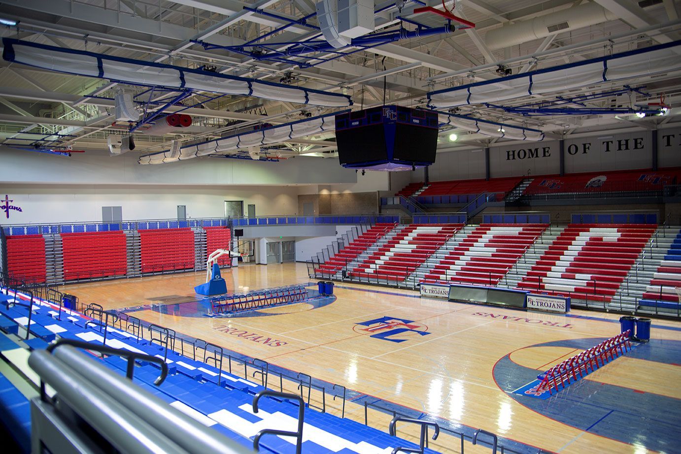 The gymnasium floor at Trojan Arena in CO that features EXCEL Seat Modules in red, white and blue colors for a striking look!