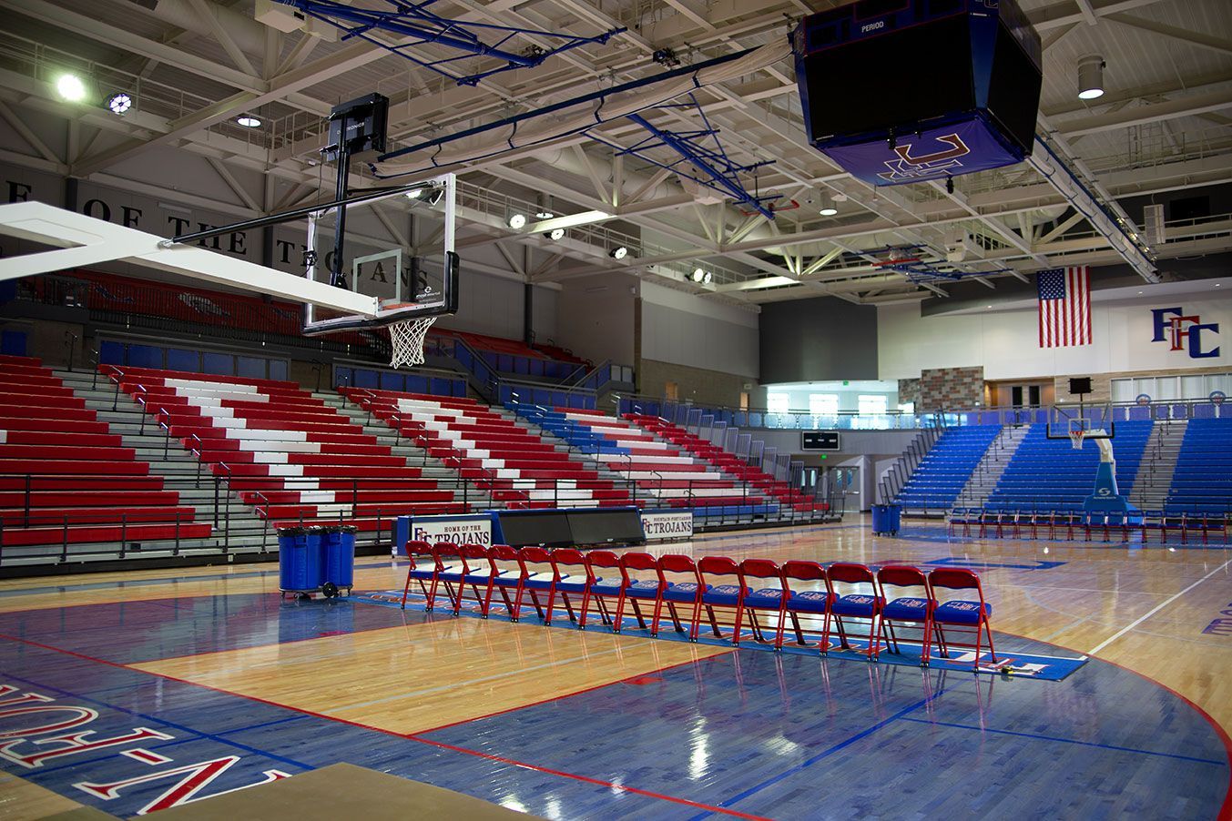 The gymnasium floor at Trojan Arena in CO that features EXCEL Seat Modules in red, white and blue colors for a striking look!